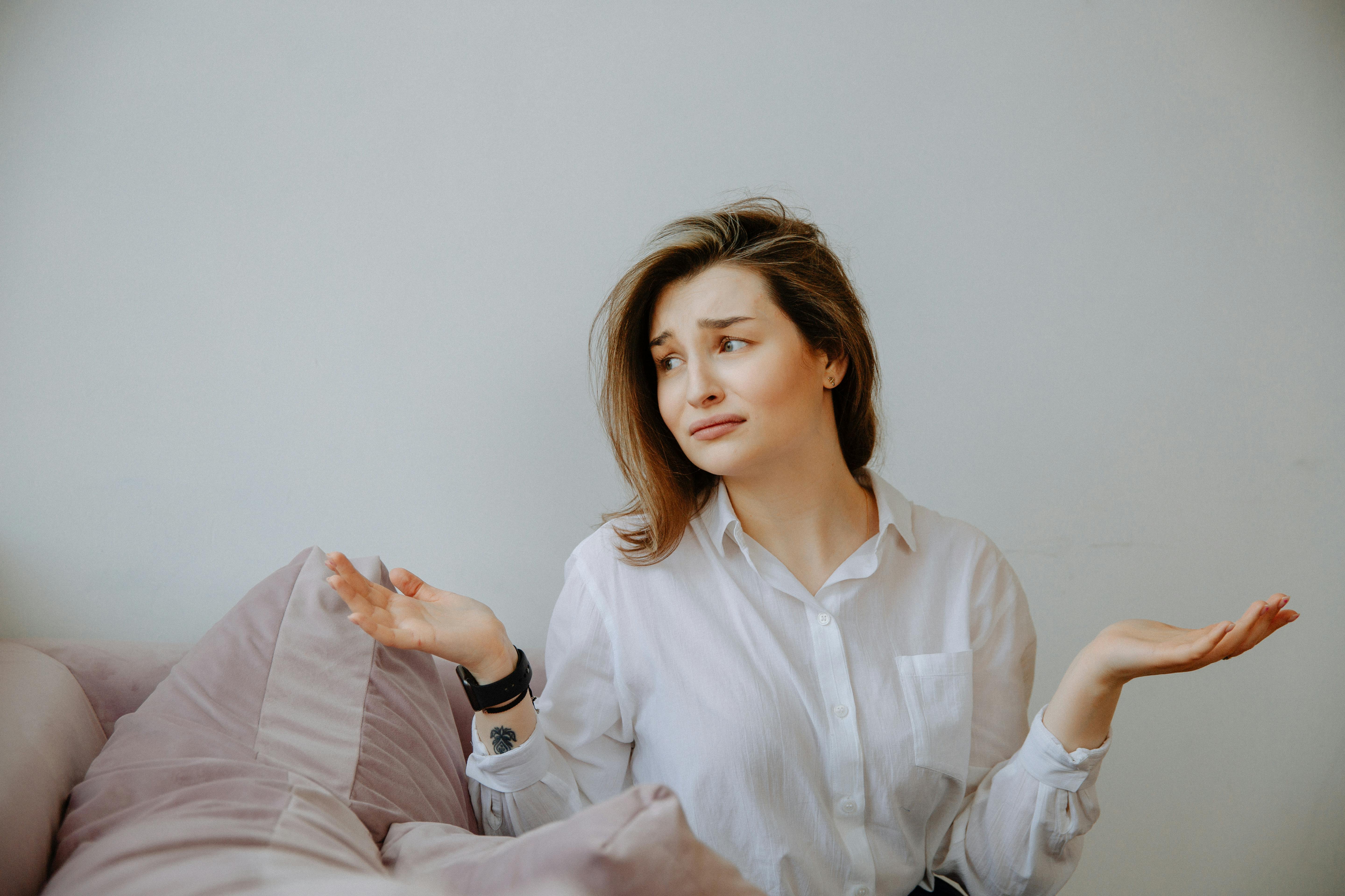 A confused and upset woman gesturing with her hands | Source: Pexels