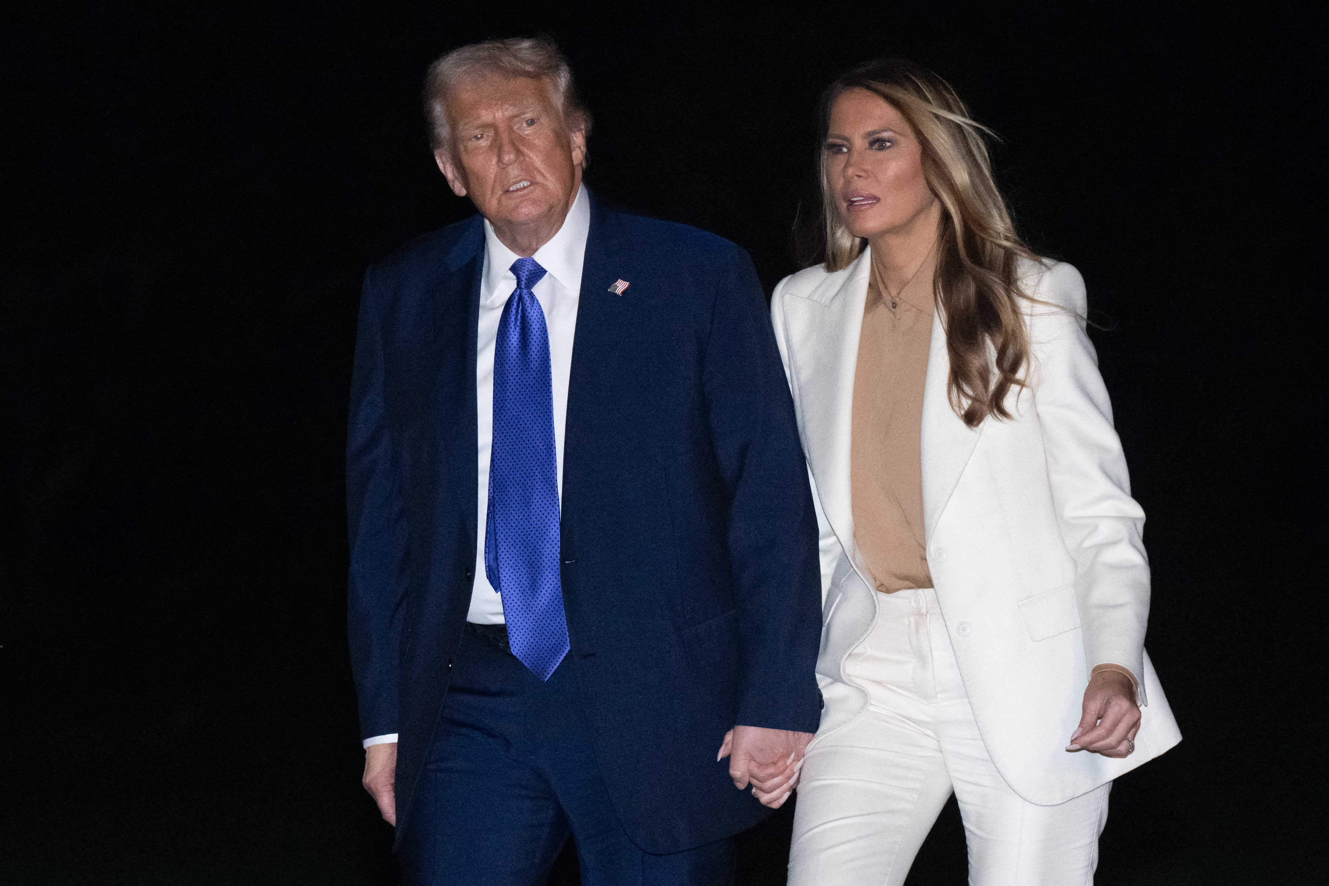 U.S. President Donald Trump and U.S. First Lady Melania Trump walking hand-in-hand to the White House on the South Lawn in Washington, D.C., on September 23, 2025. | Source: Getty Images