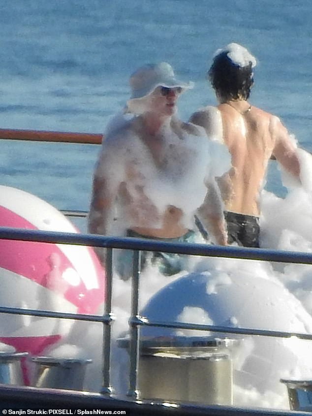 Pictured: A soapy Bezos enjoying the festivities