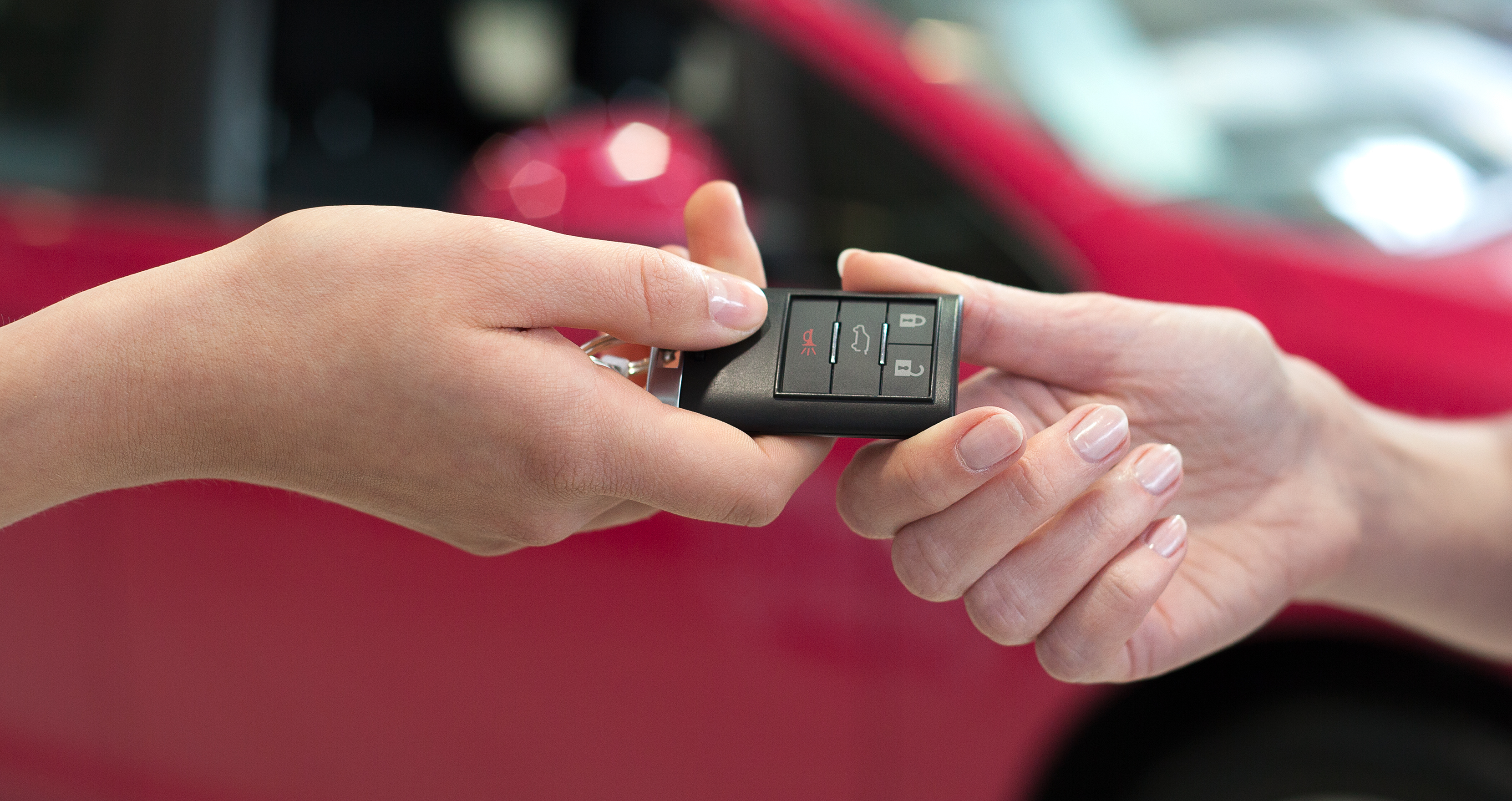 Woman handing over the keys for a car to a another woman. | Source: Shutterstock