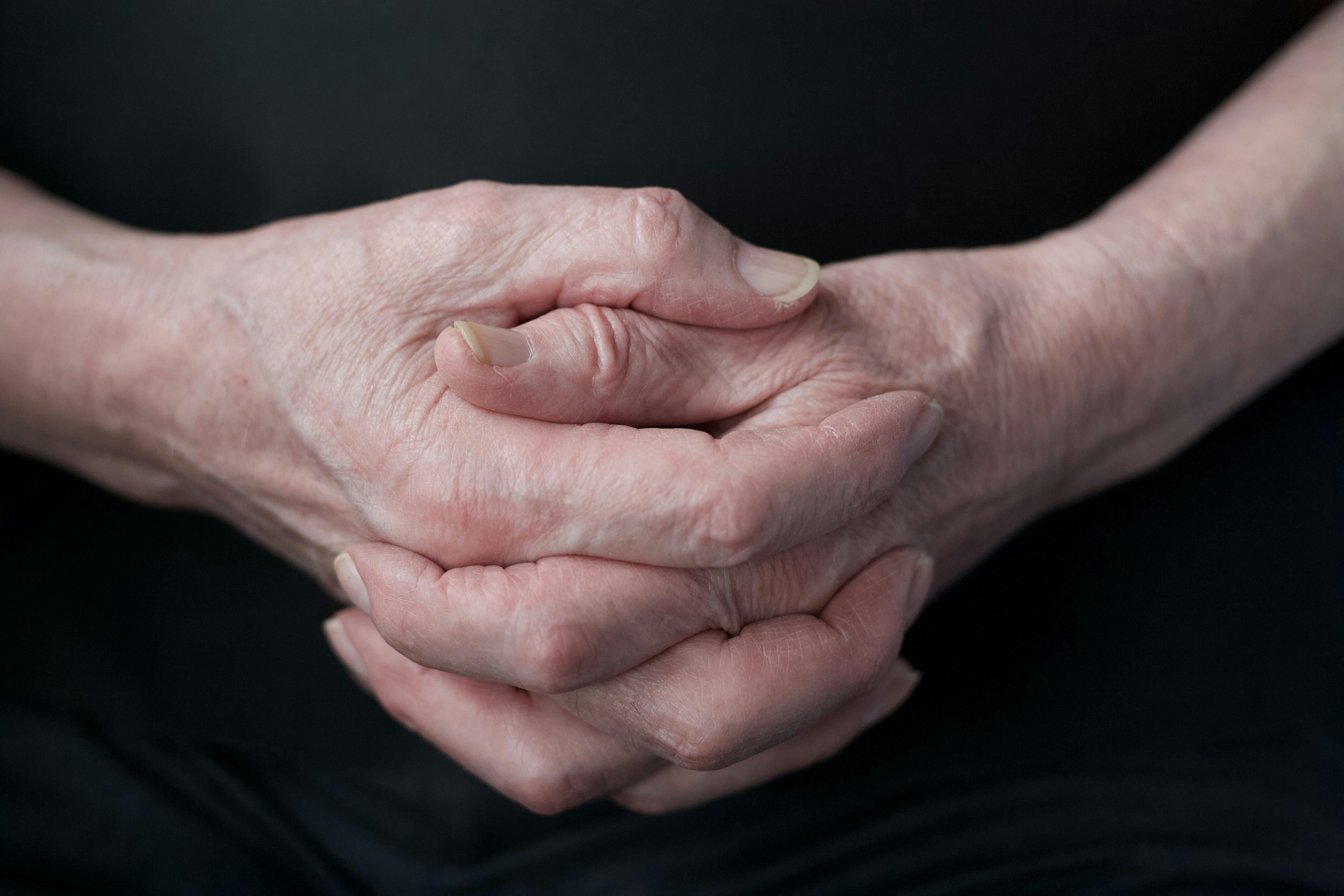 A close-up of a man's clasped hands | Source: Pexels