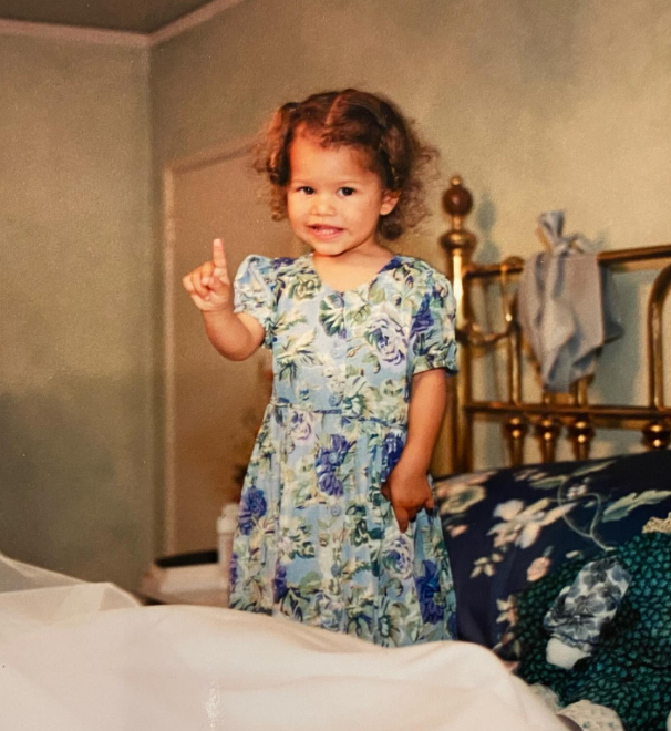Although she was shy during her early childhood, she soon developed a vibrant and expressive personality. In this photo, she posed in a bed in a throwback image uploaded on September 2, 2024. | Source: Instagram/zendaya