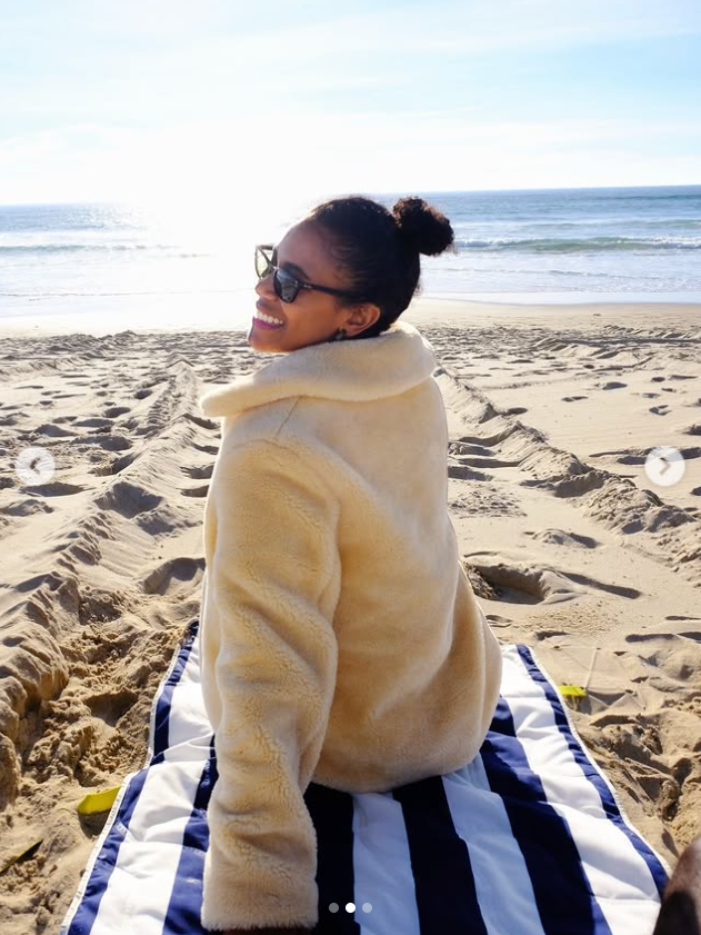 Marissa George smiles over her shoulder during a beach outing in a photo shared on February 25, 2026. | Source: Instagram/rissa.george