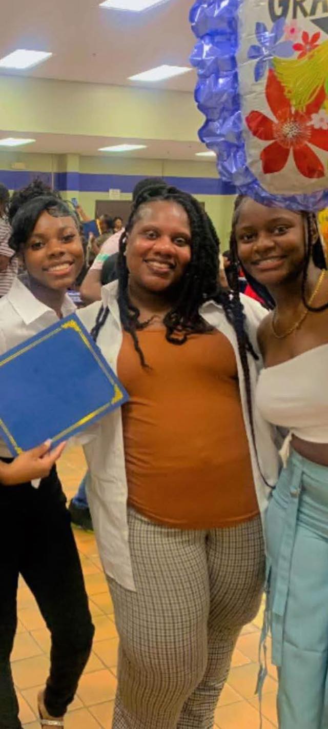 A photo of Saturah Hayes smiling with loved ones, posted on May 11, 2026. | Source: Facebook/OC ParkerJr