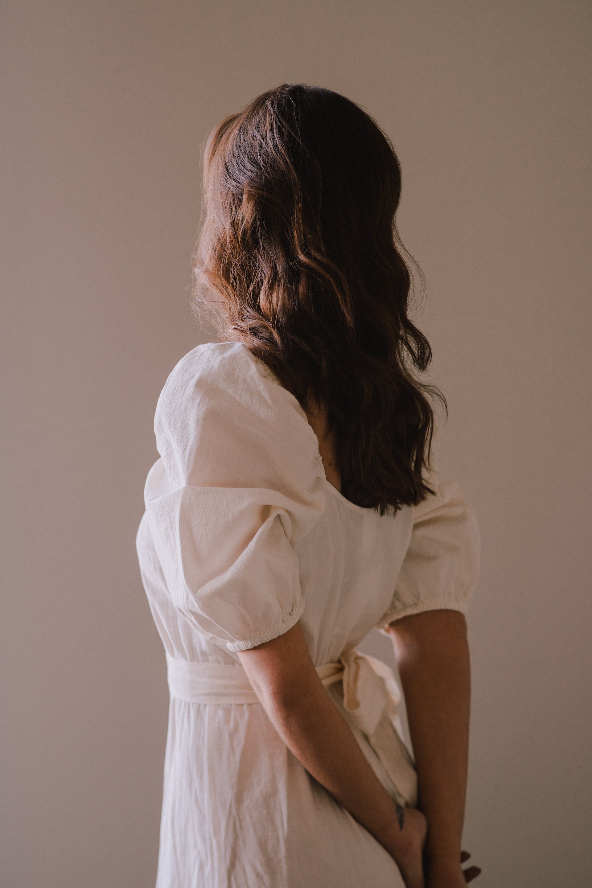 Woman standing in white dress | Source: Pexels