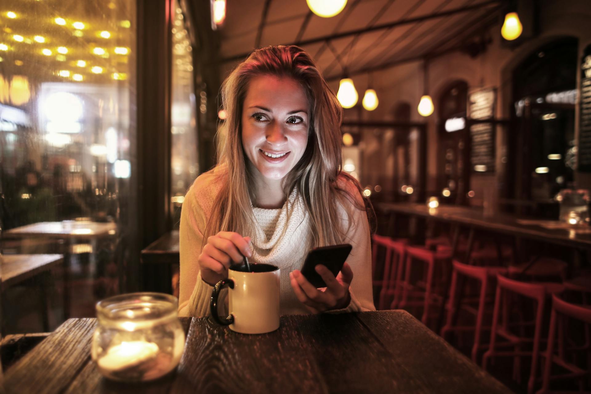 A smiling woman seated in a restaurant | Source: Pexels