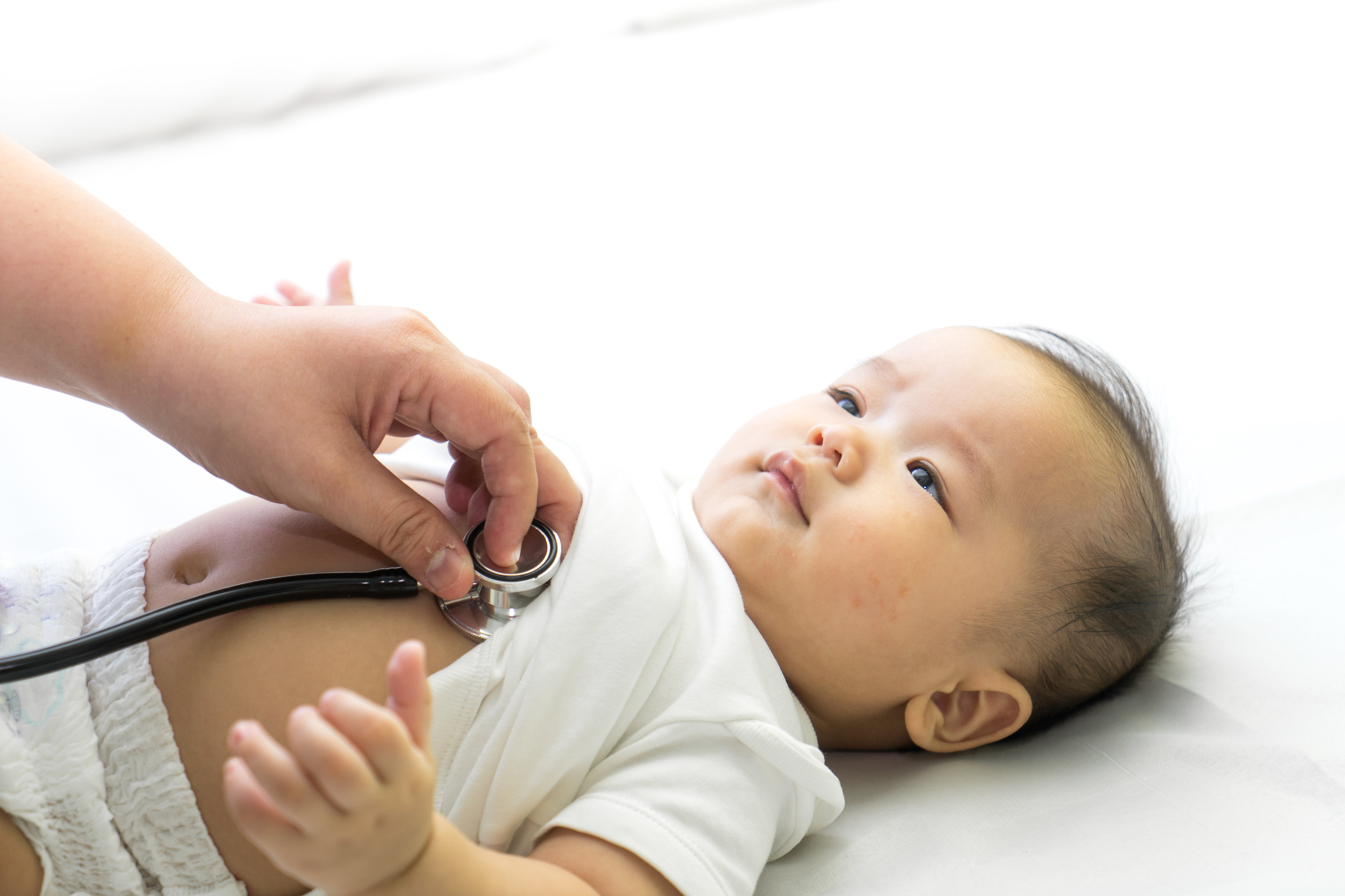 Doctor exams Asian newborn baby with stethoscope. | Photo: Shutterstock