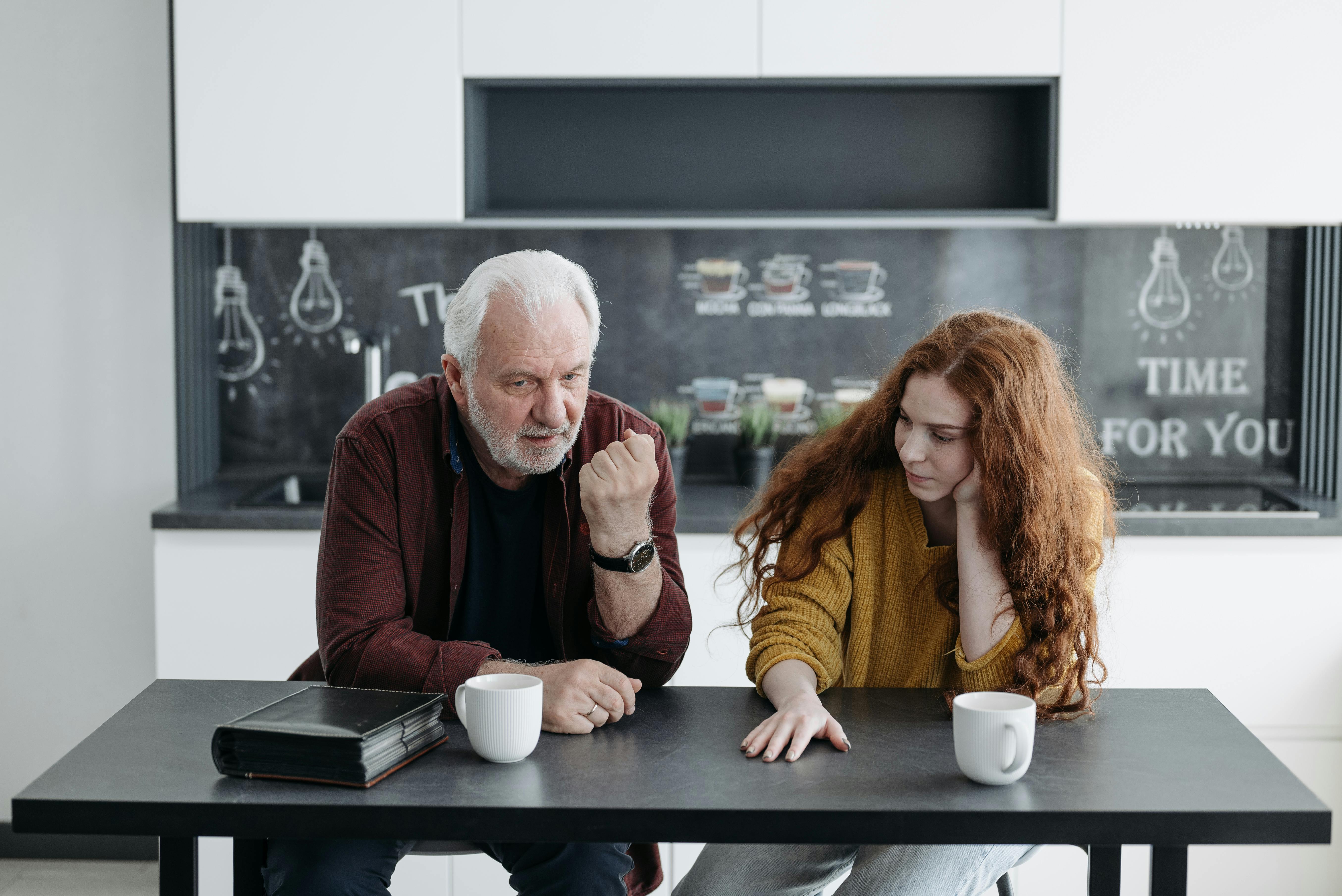An older man having a serious conversation with a younger woman | Source: Pexels
