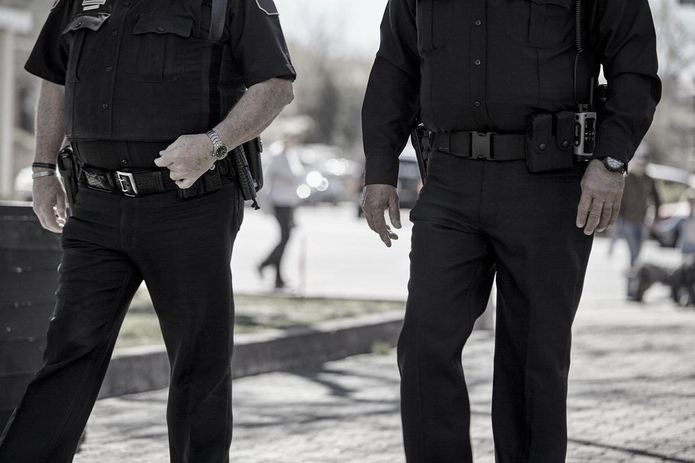 Two police officers walking in uniform in snowy area | Photo: Shutterstock