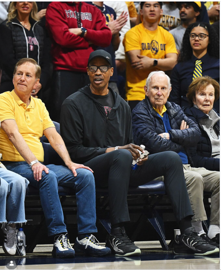 Jason Collins sits courtside during a Stanford men’s basketball game as fans fill the stands behind him. | Source: Instagram/stanfordmbb