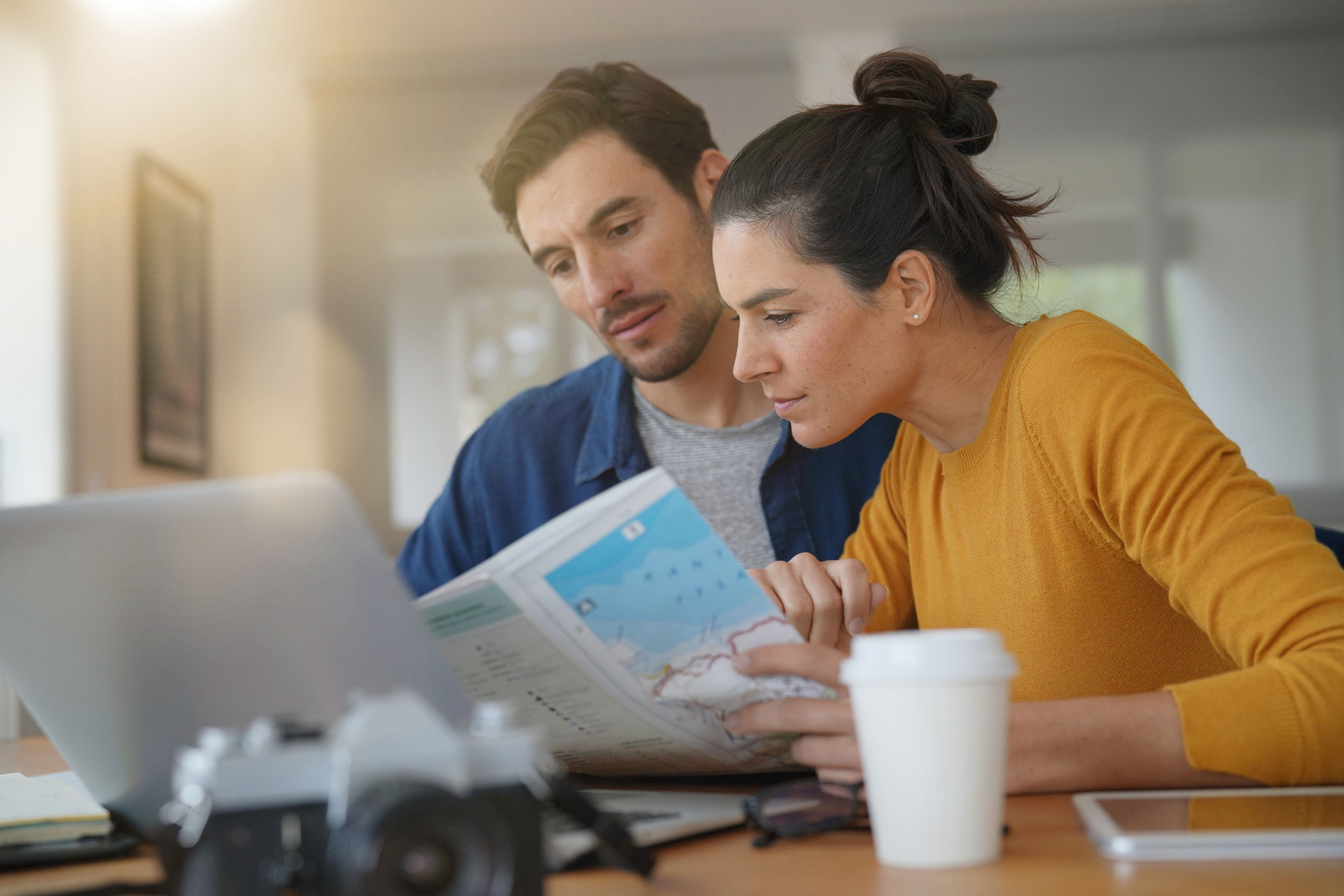 A happy couple doing research together | Source: Shutterstock