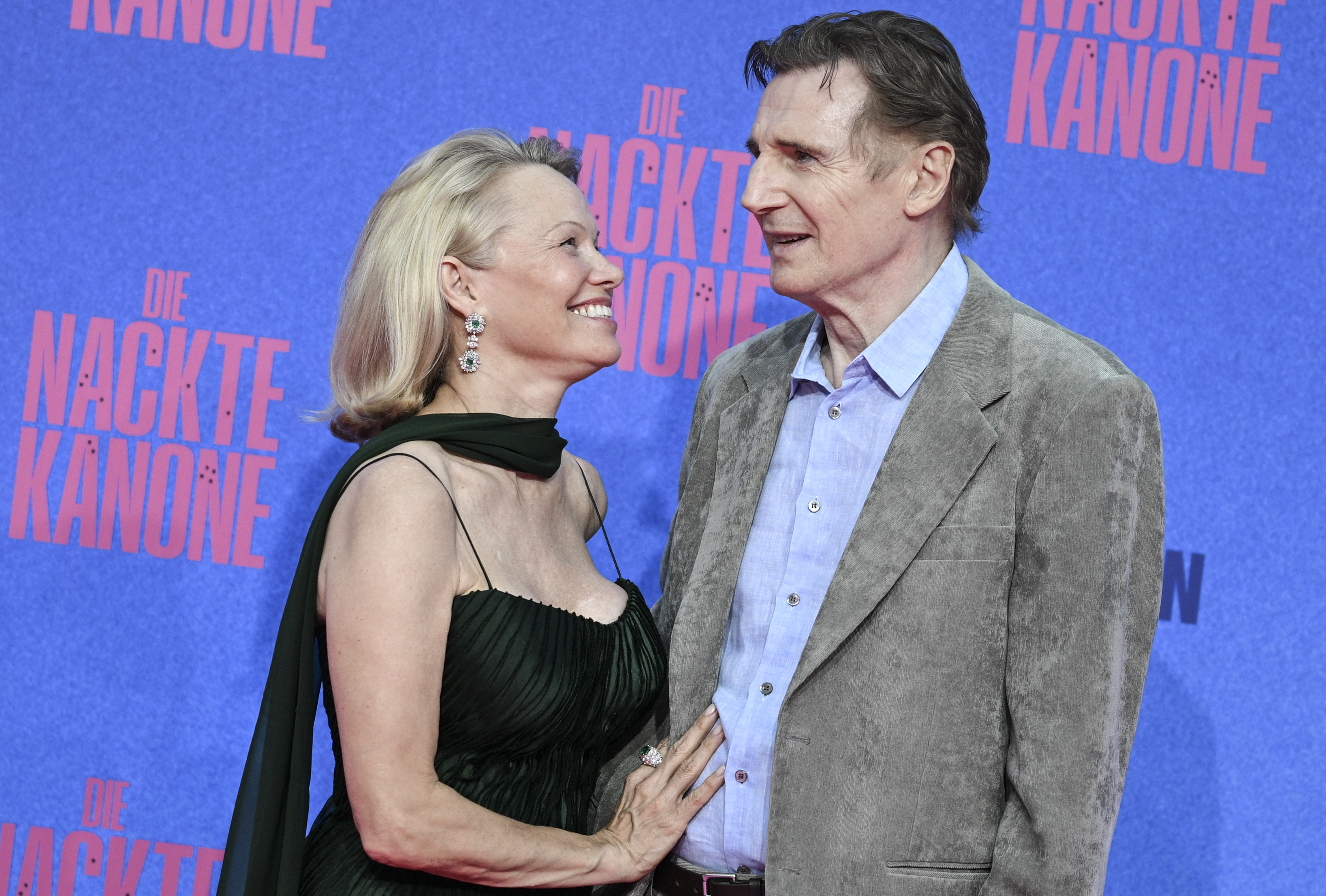 Liam Neeson and Pamela Anderson attend the German premiere of "The Naked Gun" at the UCI Luxe East Side Gallery in Berlin on July 24, 2025. | Source: Getty Images
