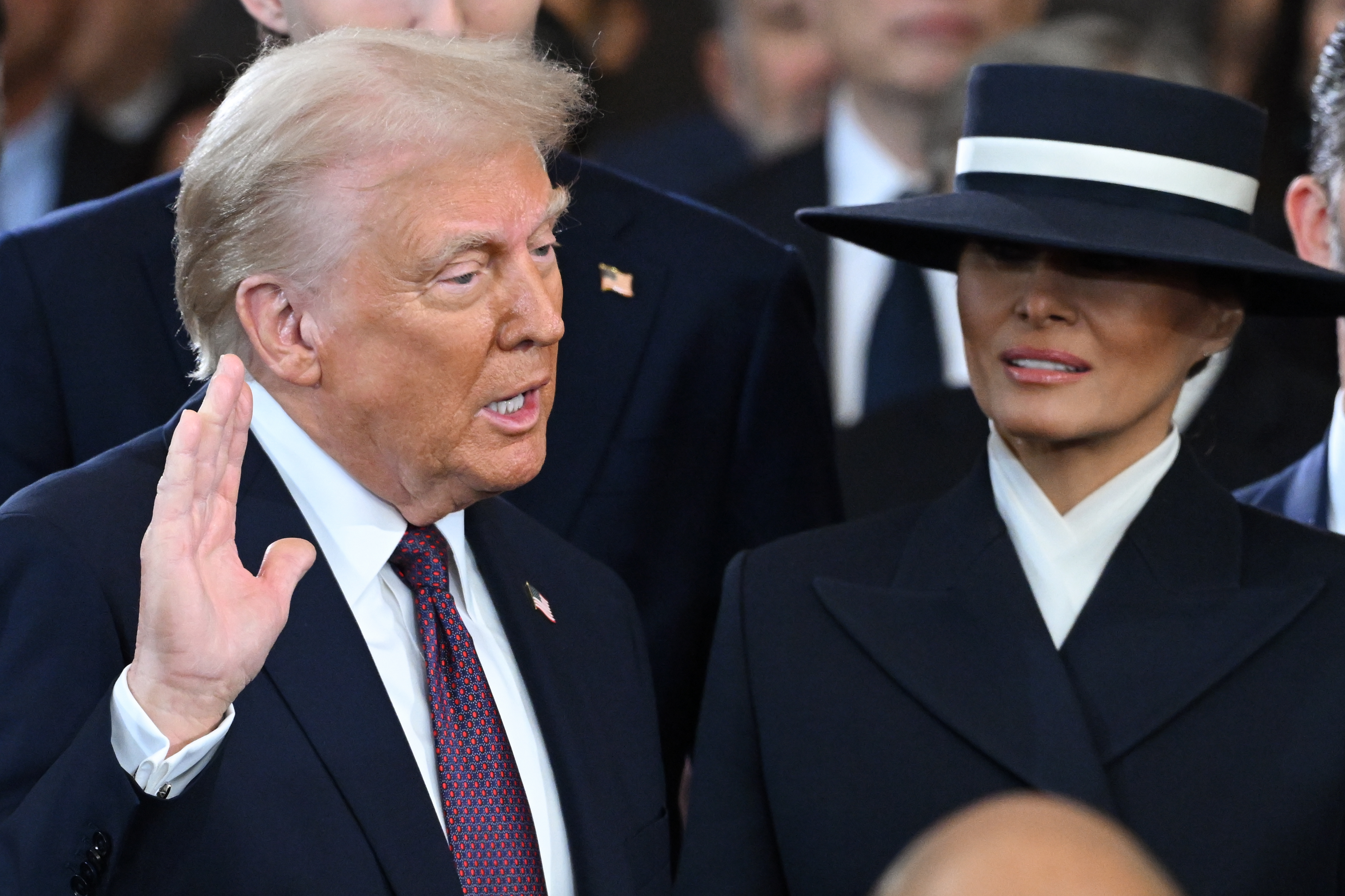 Donald Trump is sworn into office as Melania Trump holds the Bible in the US Capitol Rotunda in Washington, DC, on January 20, 2025 | Source: Getty Images