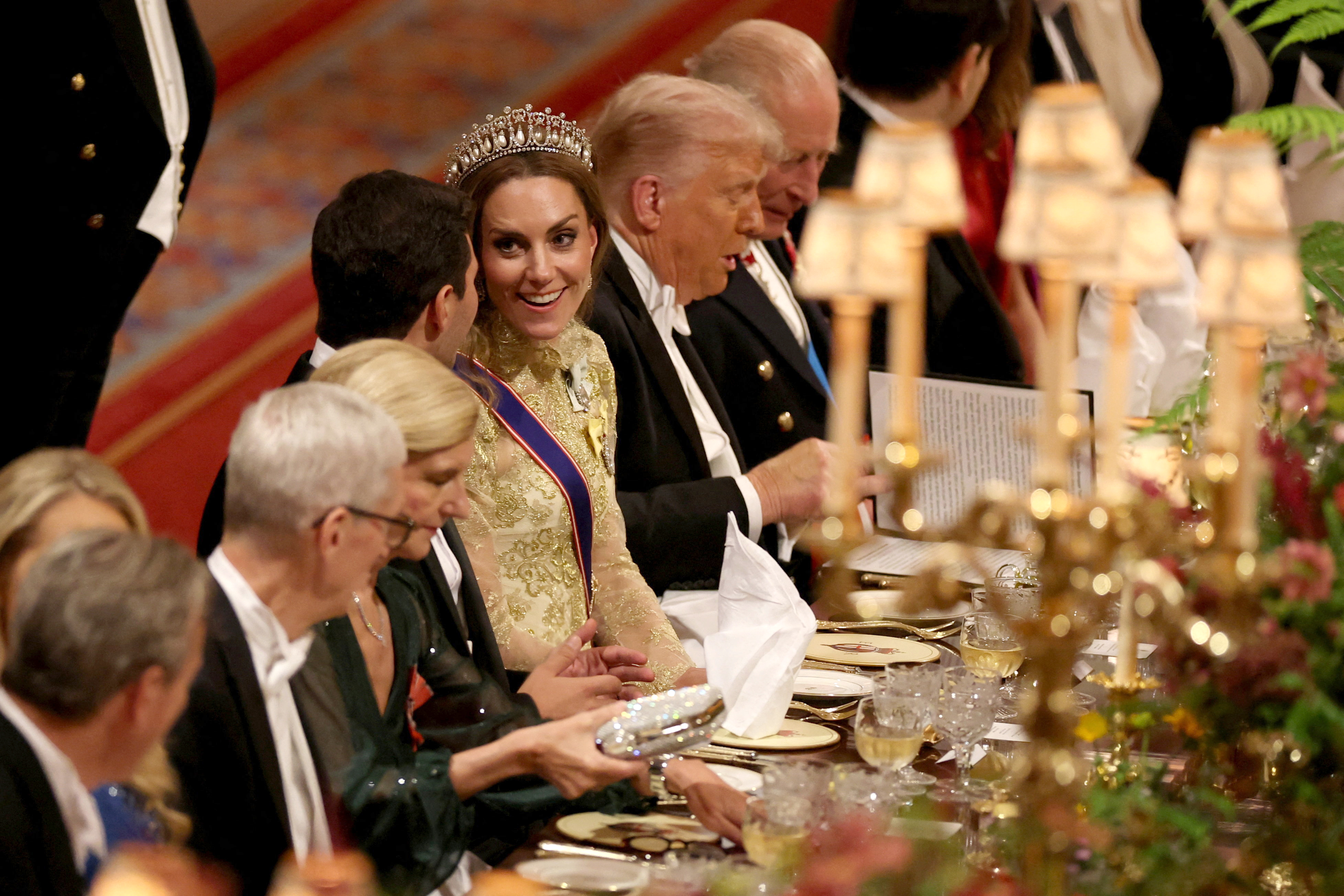 Princess Catherine chatting with a guest, while seated next to U.S. President Donald Trump, at the State Banquet in Windsor, England on September 17, 2025. | Source: Getty Images