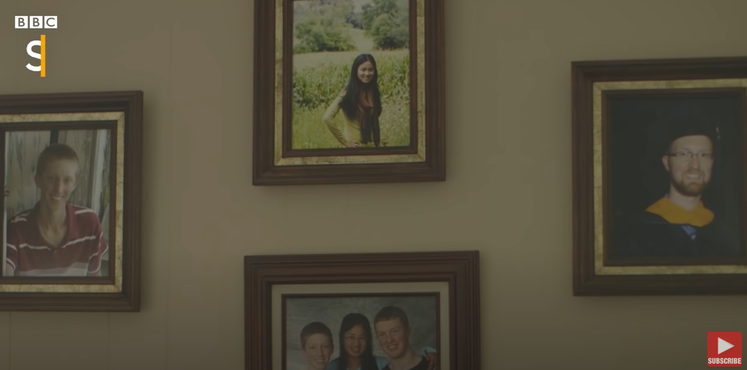 Kati Pohler and her siblings' framed photos in her adopted parents home on December 8, 2017 | Source: YouTube/BBC Stories