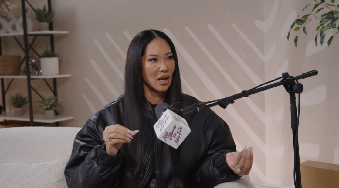 Kimora Lee Simmons makes a point with expressive hand gestures while reflecting on the emotional impact of the situation | Source: YouTube/notskinnybutnotfat