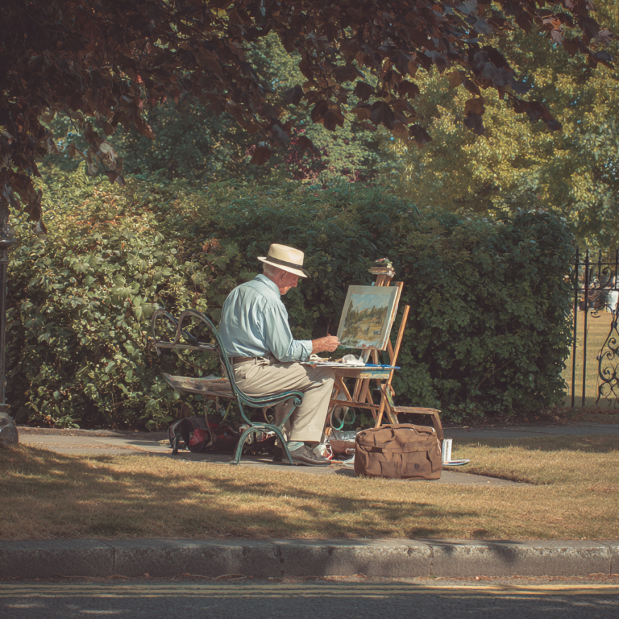A man painting in a park | Source: Midjourney
