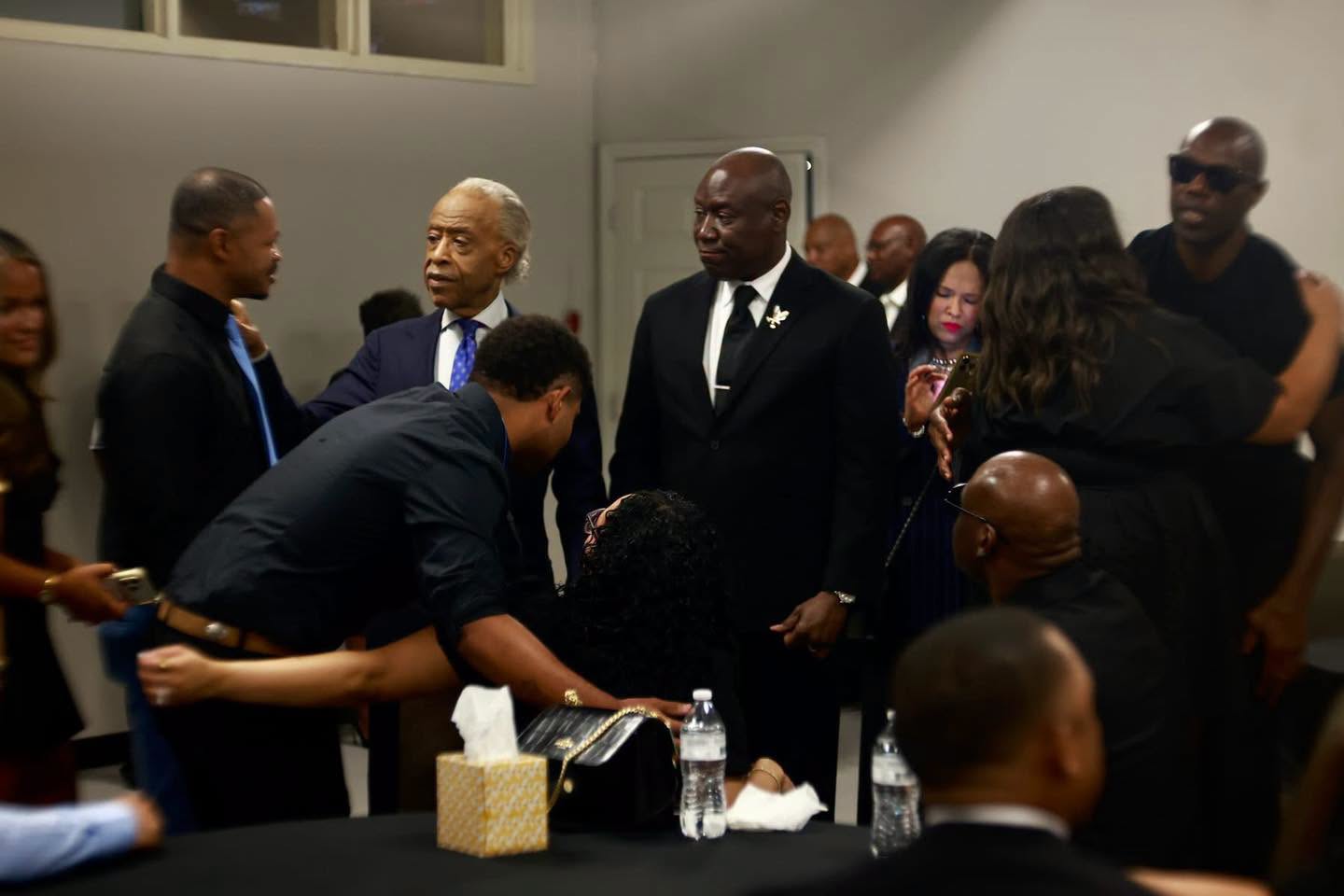Rev. Al Sharpton and Ben Crump stand alongside loved ones as mourners lean in to embrace and comfort Christine Wonsley. | Source: Facebok/realsharpton