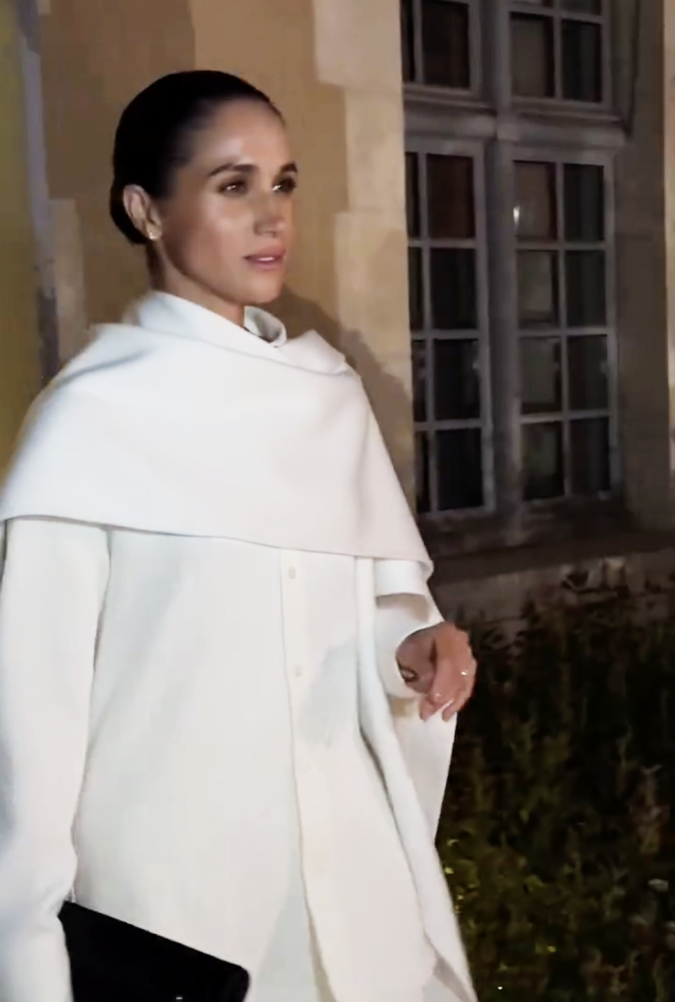 Meghan Markle, the Duchess of Sussex, is seen walking at Paris Fashion Week in an elegant white ensemble. With a calm, confident stride and a sleek bun completing the look, she commands attention amid the buzz of the event.