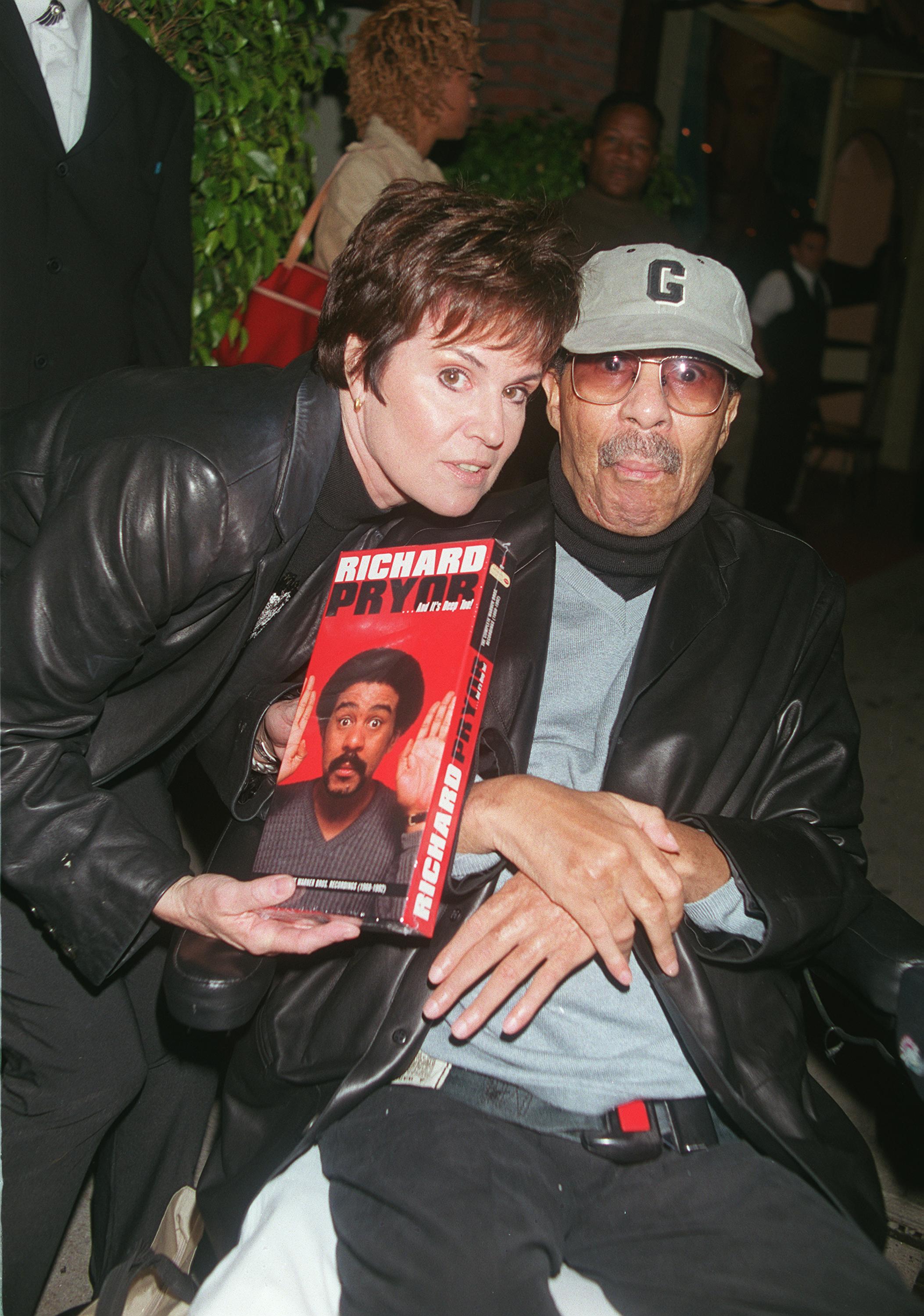 Comedian Richard Pryor and producer Jennifer Lee pose for the photographer at the Laugh Factory comedy club to promote Pryor's 9 box CD of "Richard Pryor...And It's Deep Too!" October 25, 2000 in Hollywood, CA | Getty Images