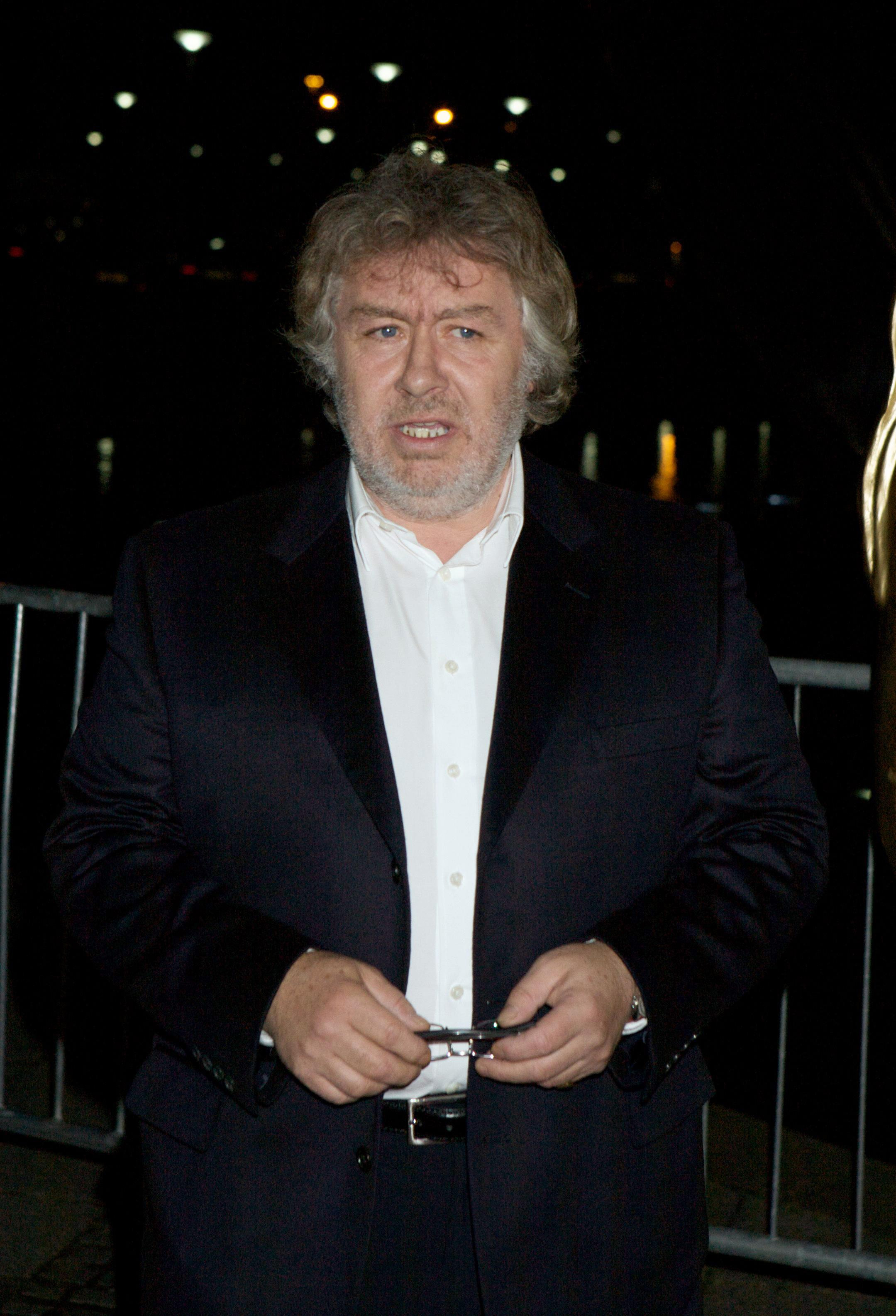 Gregor Fisher arrives at the 2009 BAFTA Scotland Awards at the Glasgow Science Centre, dressed in a dark suit and white shirt as he pauses outside the venue.