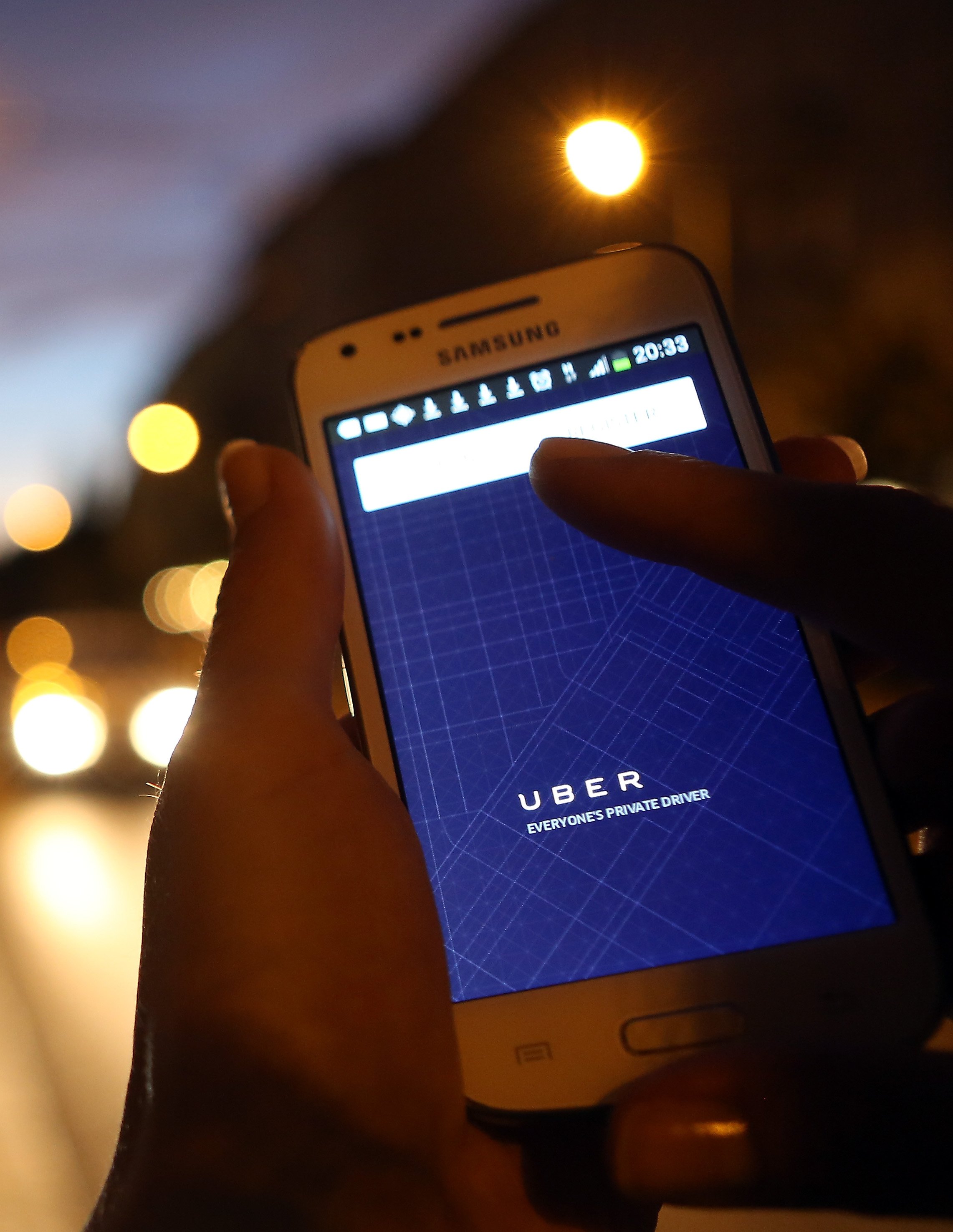 A client getting ready to call an Uber through their phone app | Photo: Getty Images