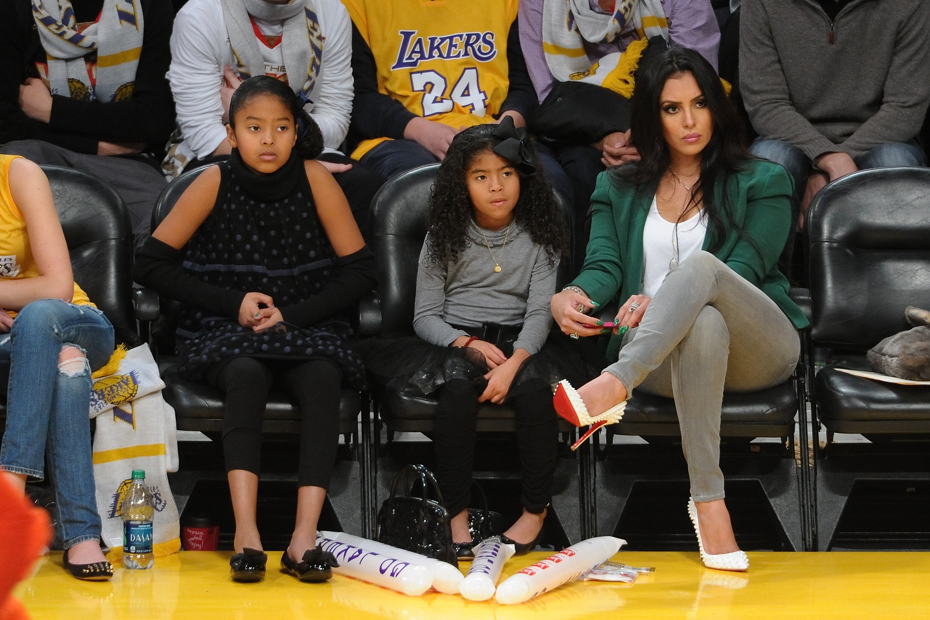 Vanessa Bryant courtside with her daughters, Natalia (Left) and Gianna (middle), December, 2012. | Photo: Getty Images.