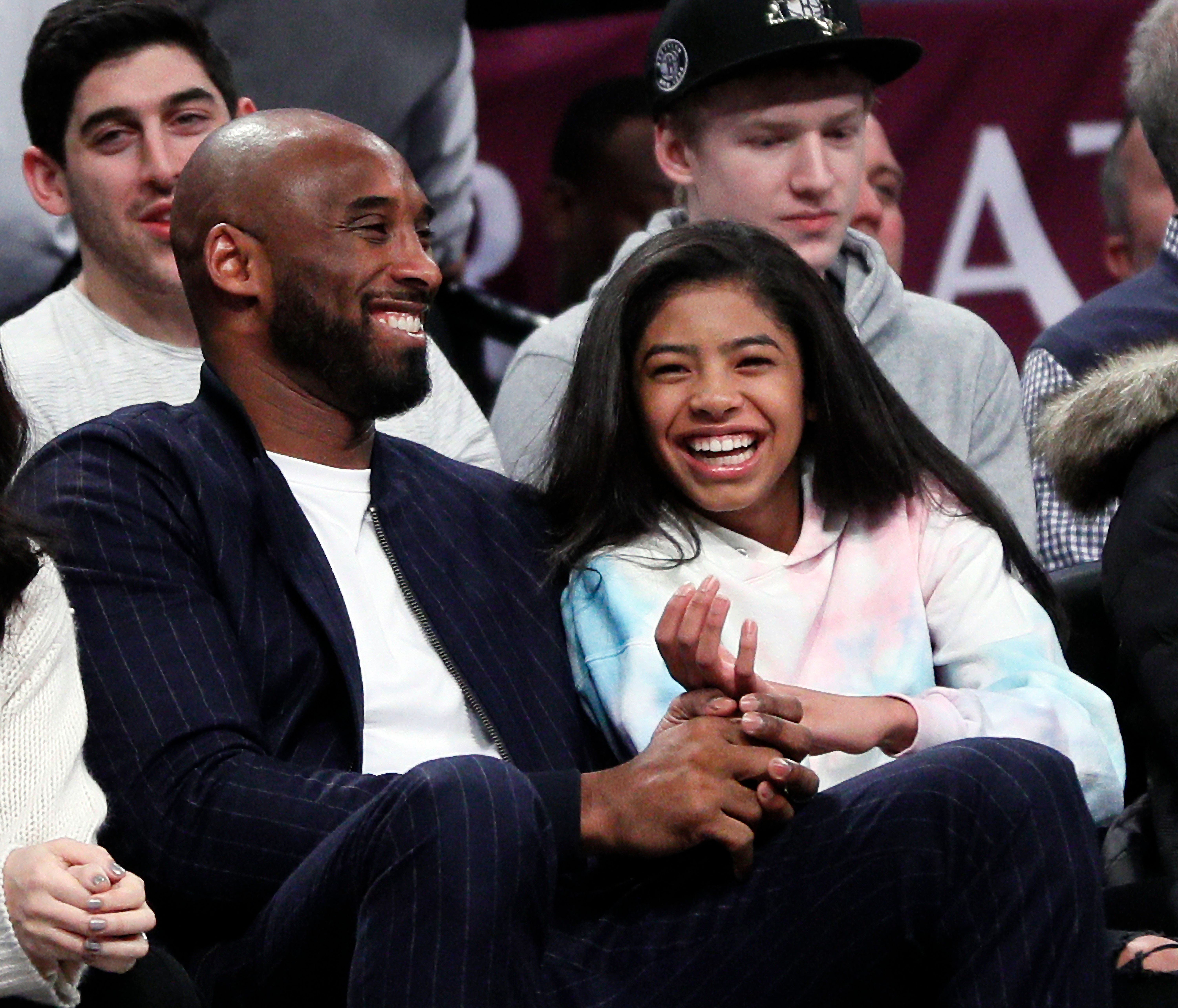 Kobe Bryant and his daughter Gigi, at an NBA basketball game between the Brooklyn Nets and Atlanta Hawks on December 21, 2019 | Photo: Getty Images