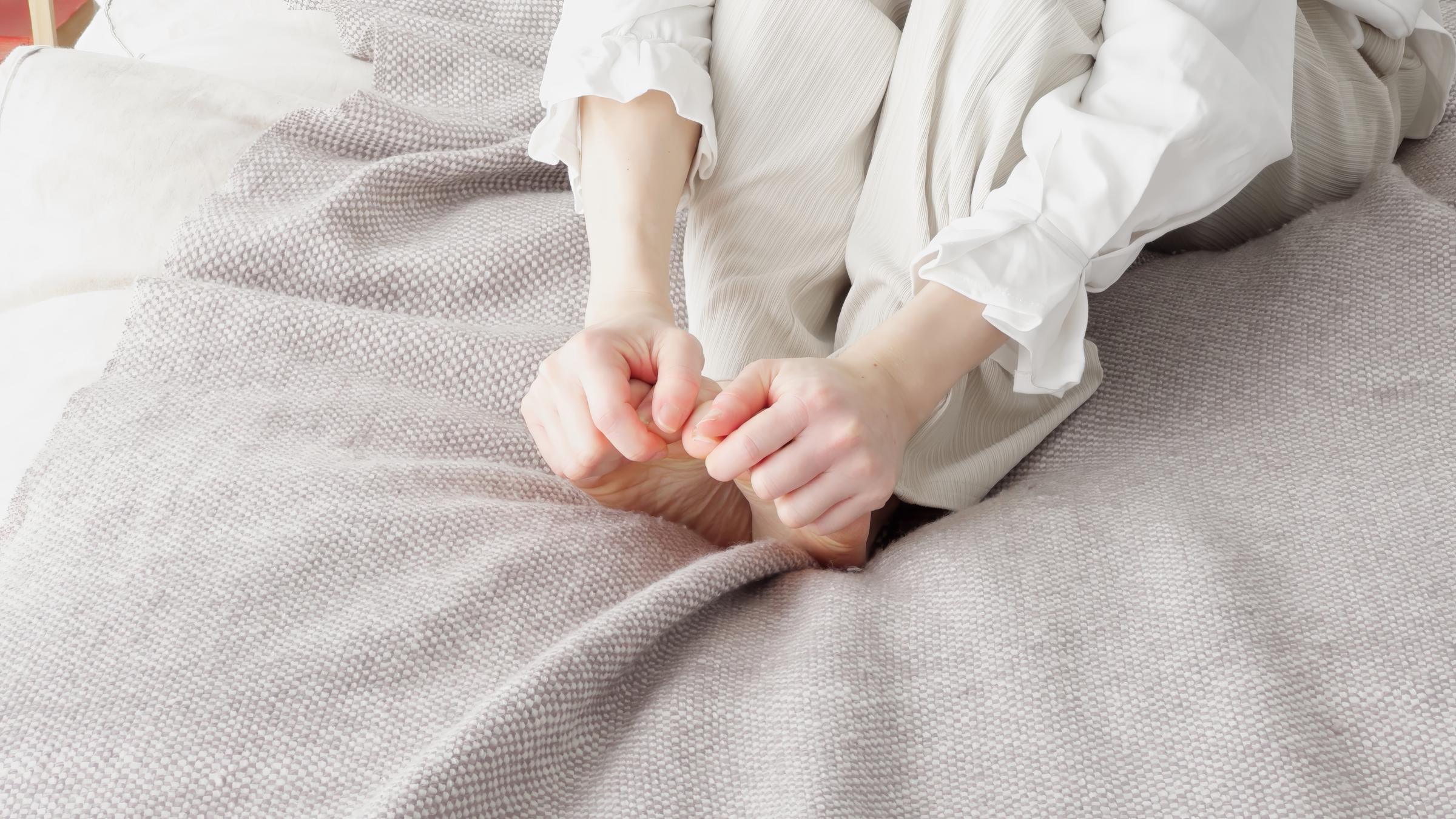 A woman rubbing her cold feet | Source: Getty Images