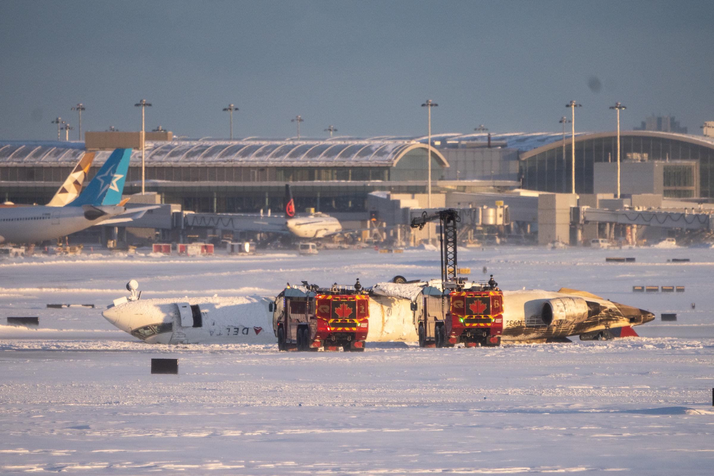 Emergency personnel work at the scene of a Delta Airlines plane crash on February 17, 2025 | Source: Getty Images