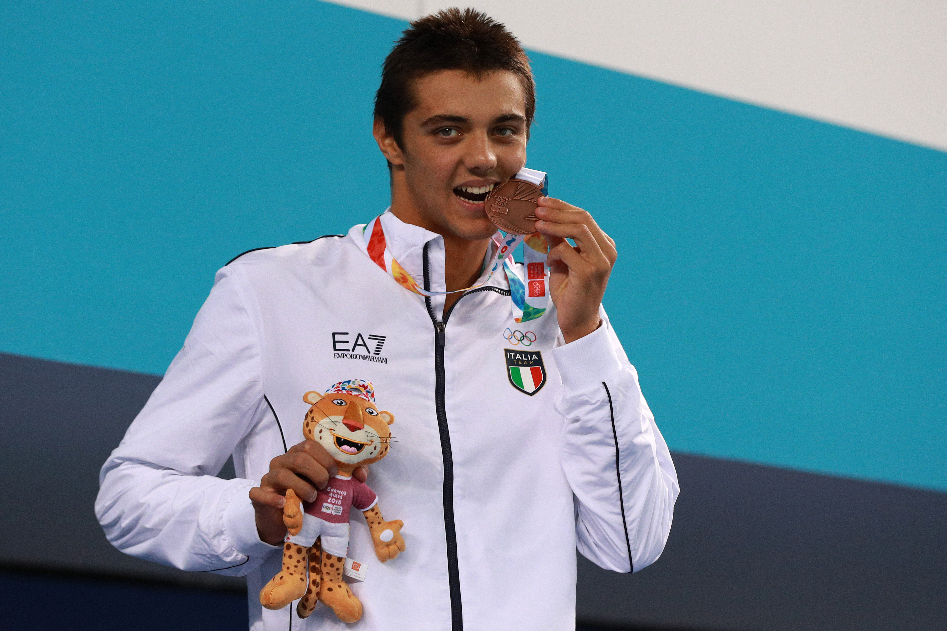 Thomas Ceccon bites his Bronze medal after competing in Men's 100m Backstroke Final in the Youth Olympic Park on October 8, 2018, in Buenos Aires, Argentina | Source: Getty Images