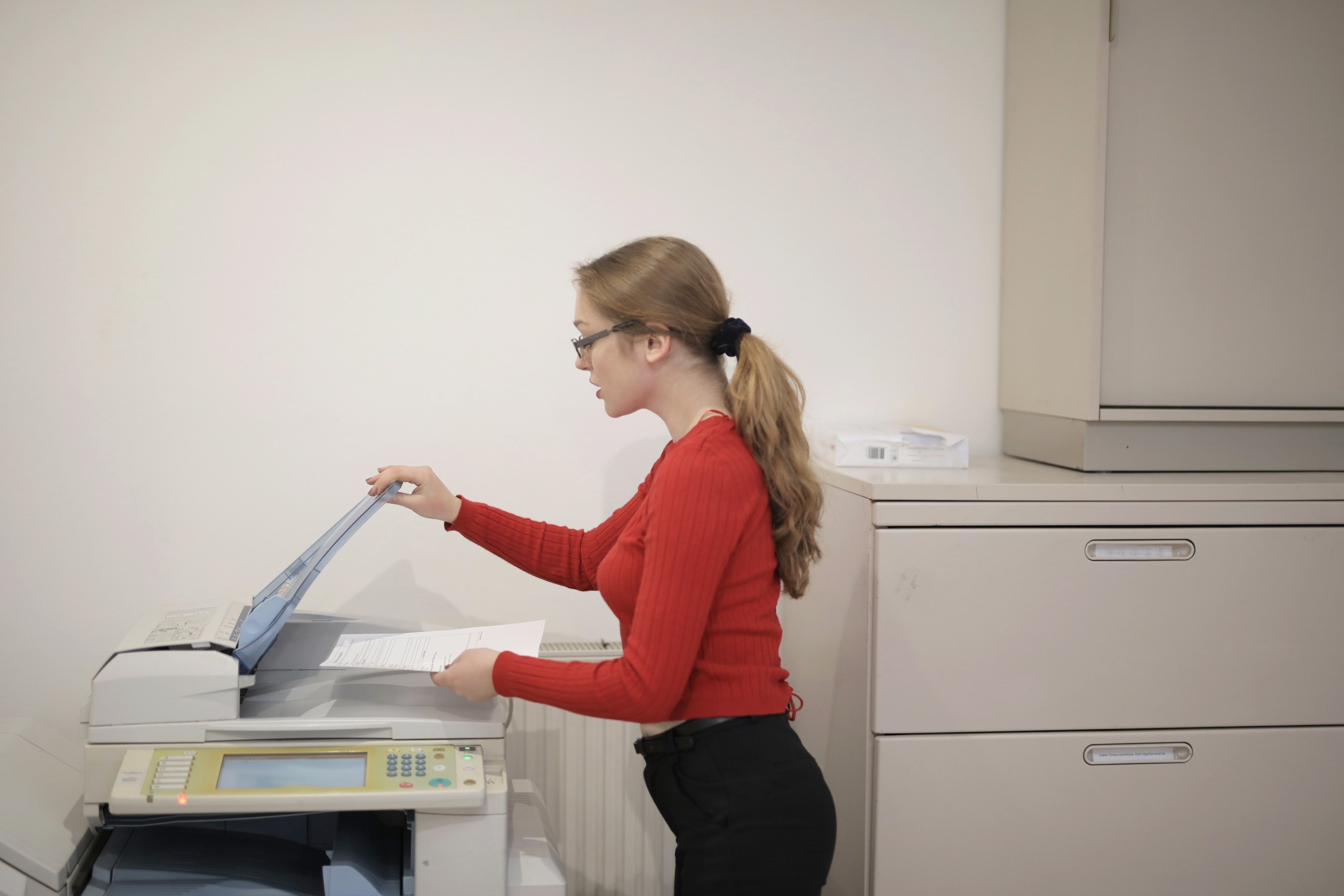 A woman using a copier. | Source: Pexels. 