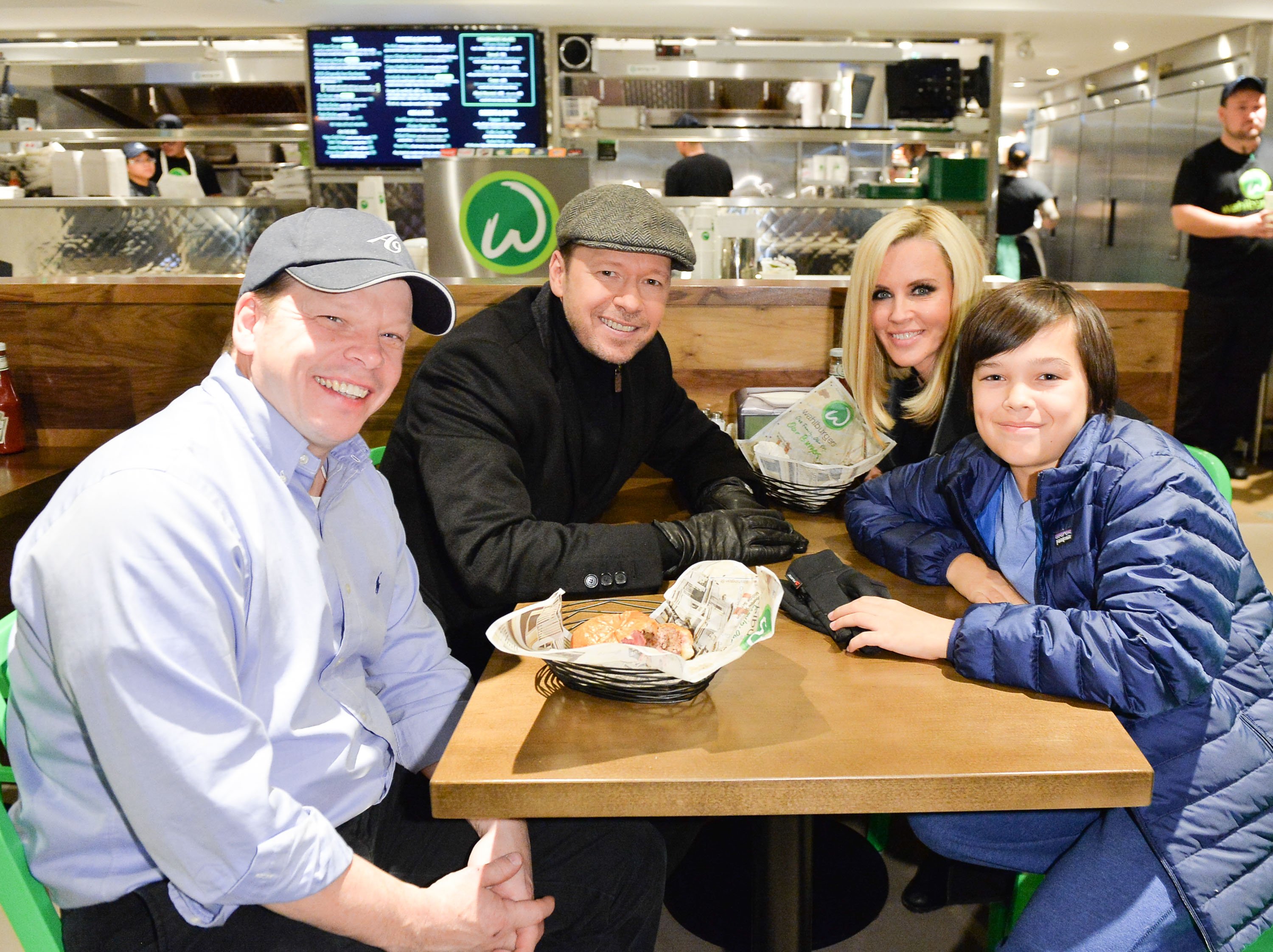Paul Wahlberg, Donnie Wahlberg, Jenny McCarthy and Elijah Wahlberg enjoy at the Canadian launch of Wahlburgers Family Restaurant on November 15, 2014 | Source: Getty Images