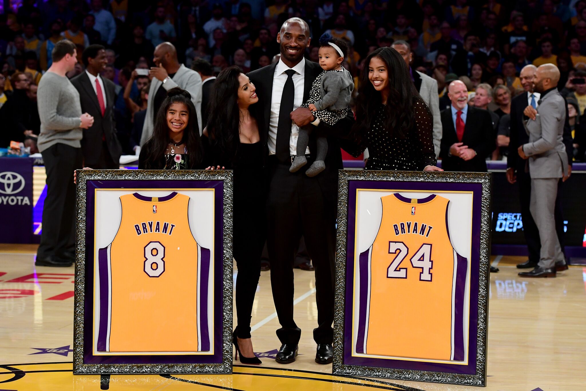 Kobe Bryant poses with his family at halftime after both his #8 and #24 Los Angeles Lakers jerseys are retired at Staples Center on December 18, 2017  | Getty Images