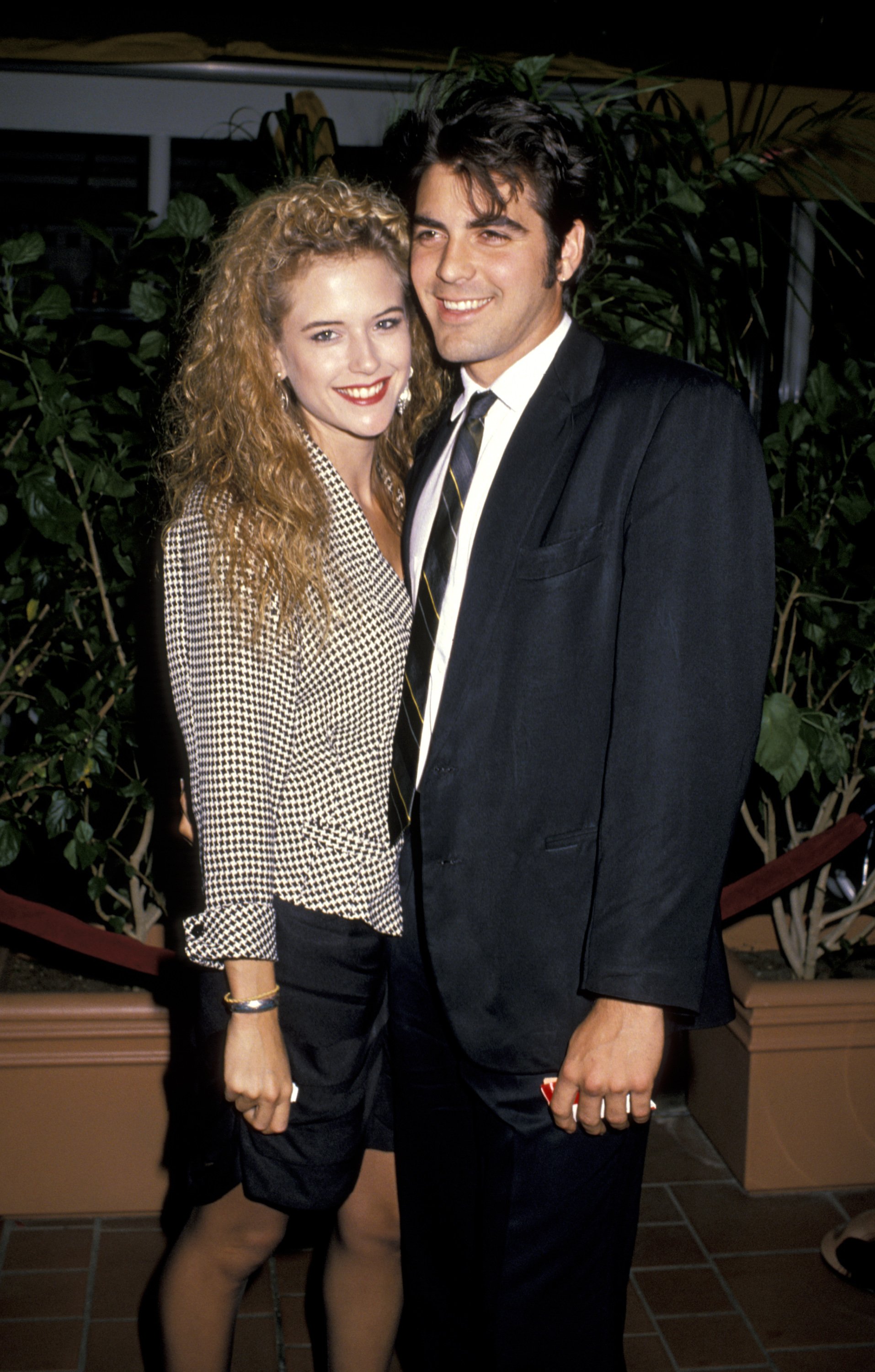 Actress Kelly Preston with her boyfriend filmmaker George Clooney at the premiere of "Twins." / Source: Getty Images