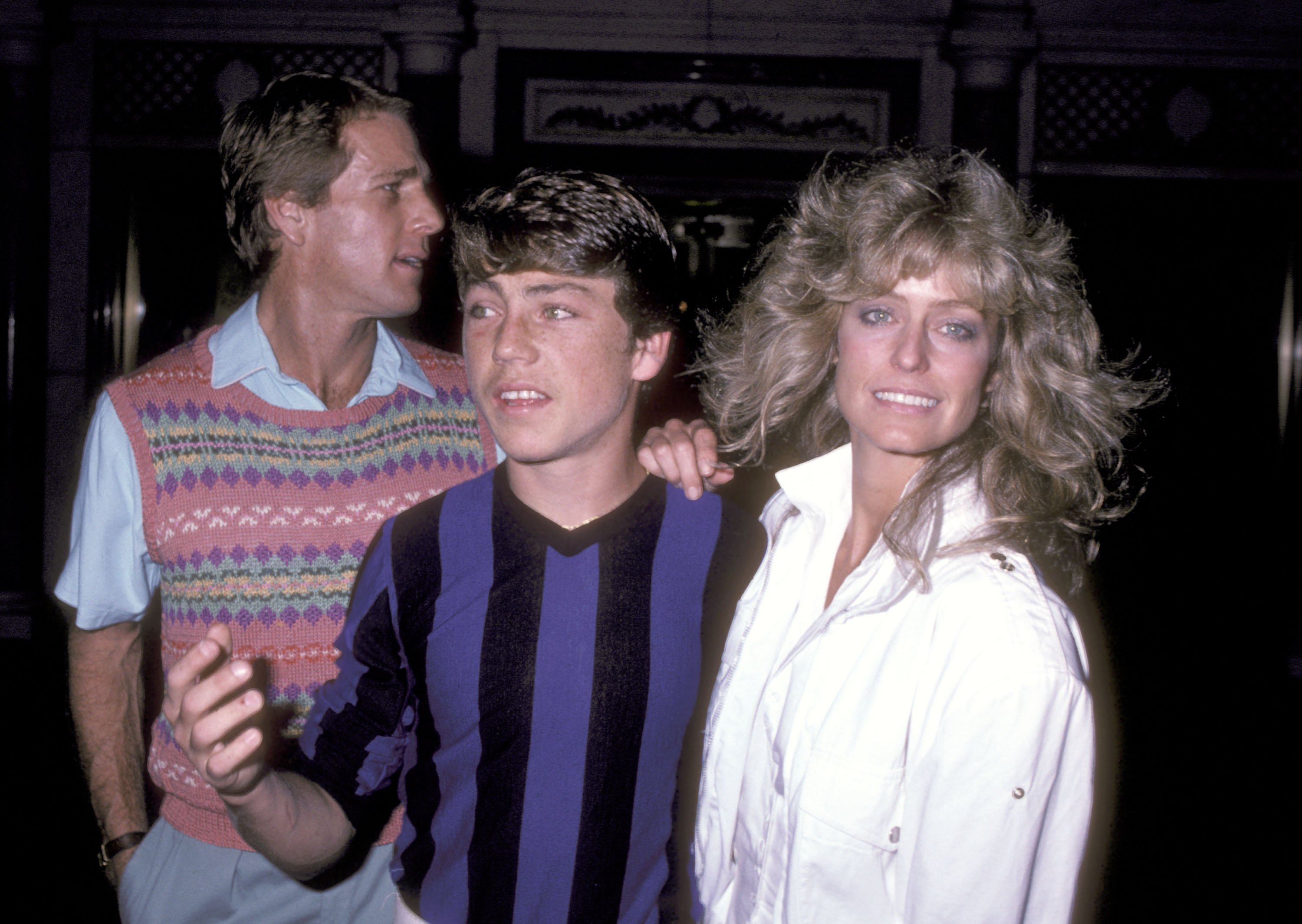 Actor Ryan O'Neal, his son Griffin O'Neal and actress Farrah Fawcett catch a performance of "Nine" at 42nd Street Theatre on June 16, 1982 in New York City.  | Source: Getty Images