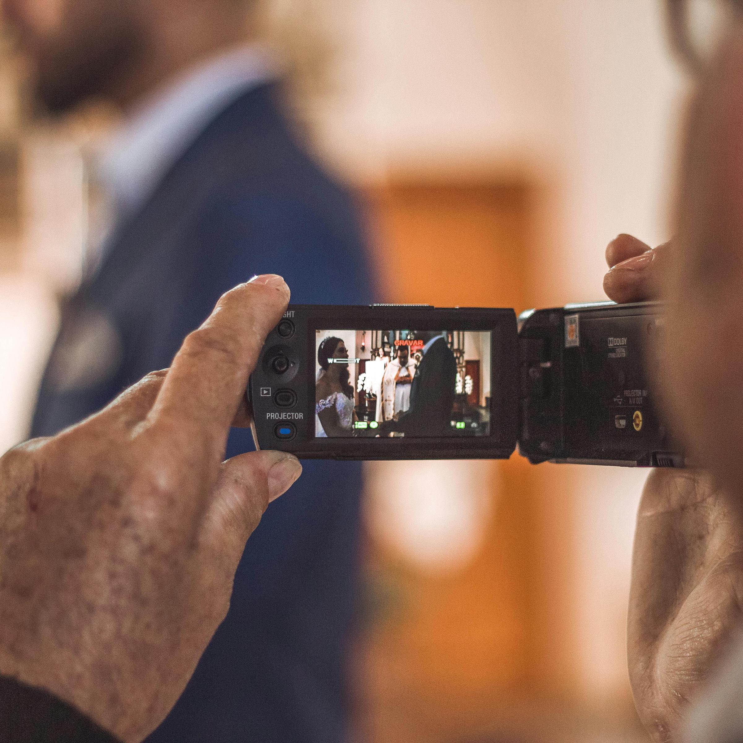 A man capturing a wedding ceremony on video | Source: Pexels