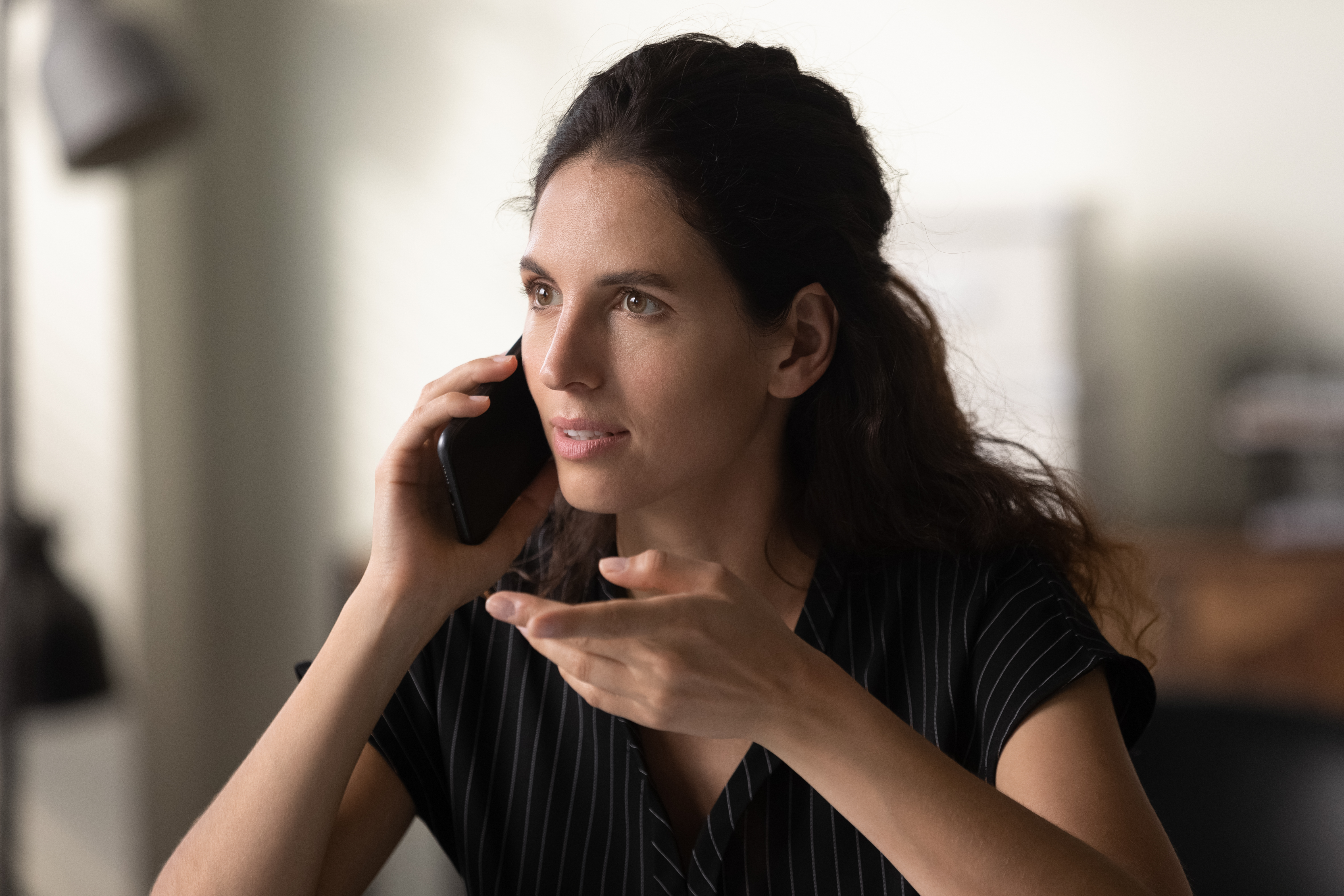 A woman talking on the phone | Source: Shutterstock