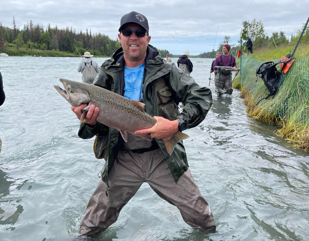 Spencer Long smiles while holding a fish during an outdoor trip, reflecting his love of spending time in nature with his family. Family members said those shared adventures were among the moments they cherished most. | Source: Facebook/katrina.g.long