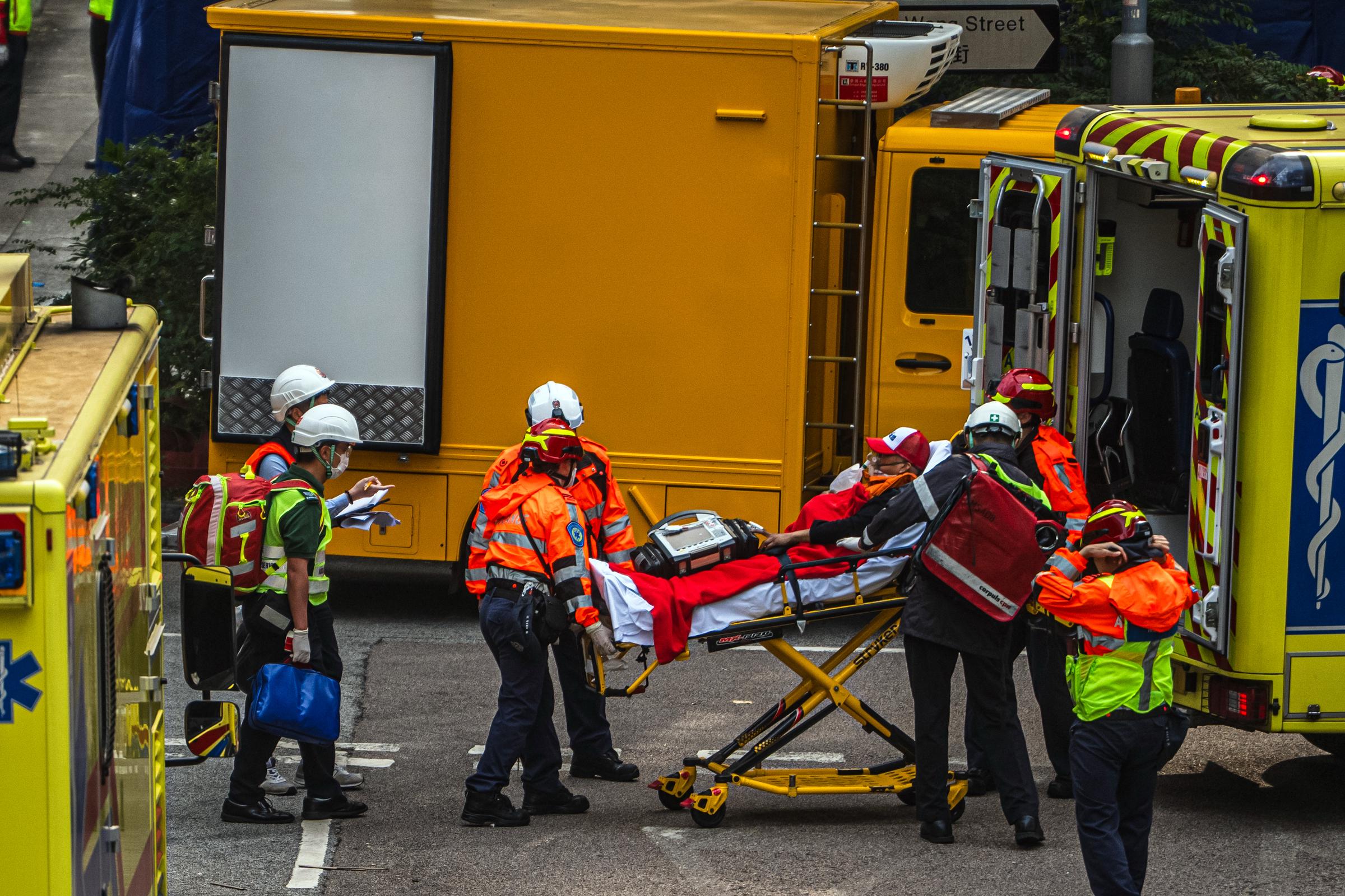 Rescue workers transport a fire victim into an ambulance outside Wang Fuk Court in Tai Po, Hong Kong, on November 27, 2025 | Source: Getty Images