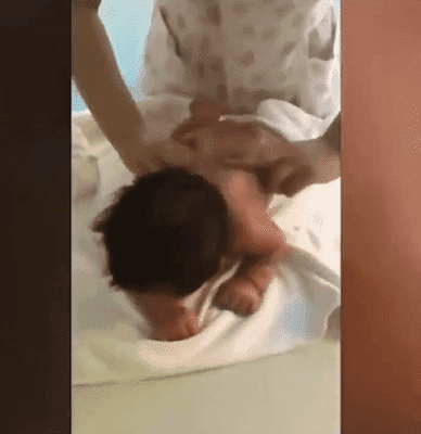 A chinese baby gets a back rub at a postnatal care center. | Photo: Twitter/China Daily