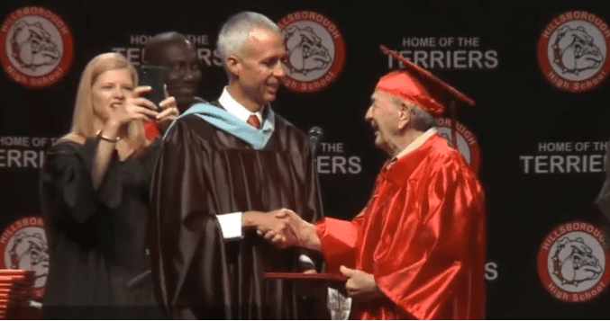 Joe Perricone receiving his diploma from Gary Brady | Photo: ABC Action News