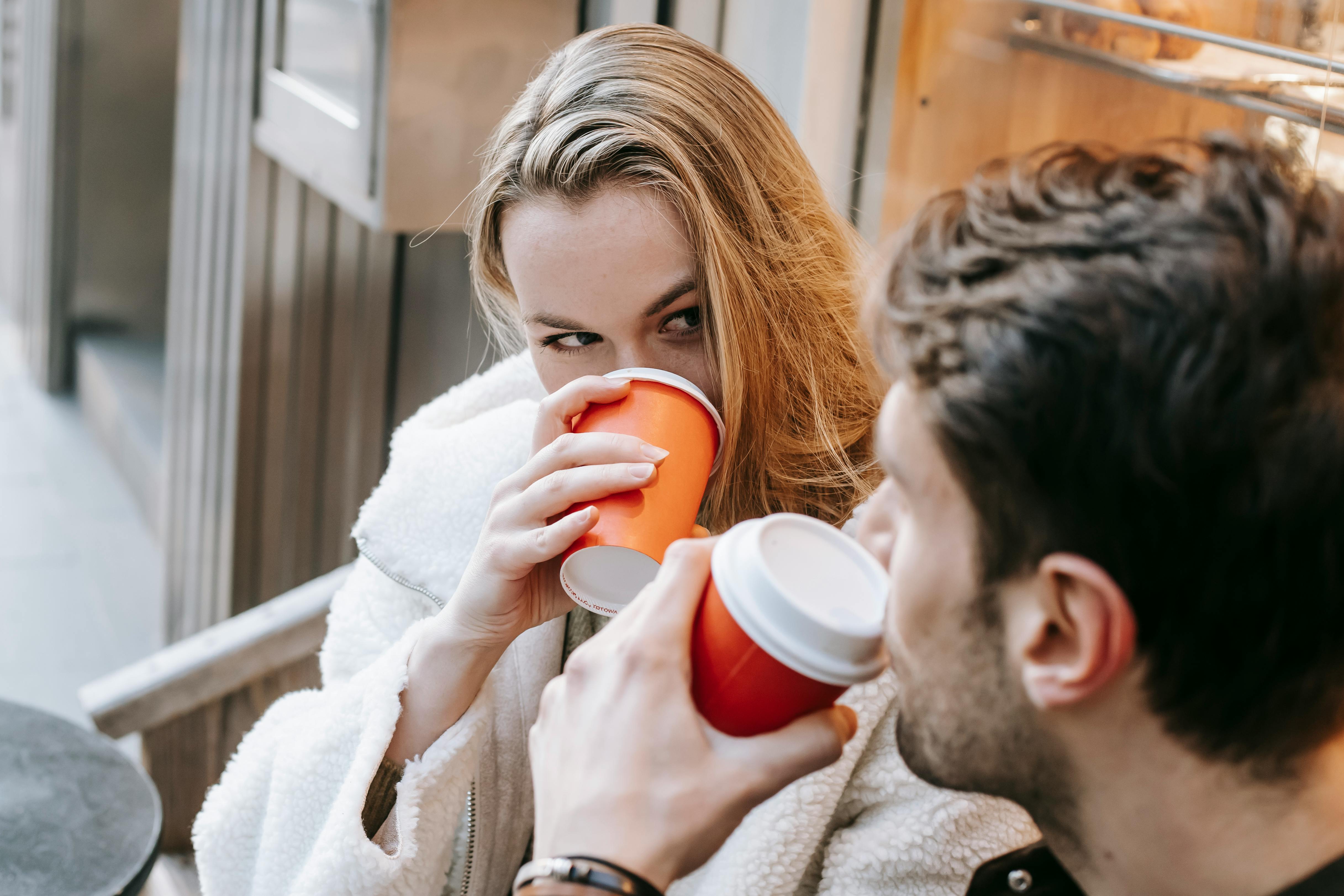 A couple looking into each other's eyes while having coffee | Source: Pexels