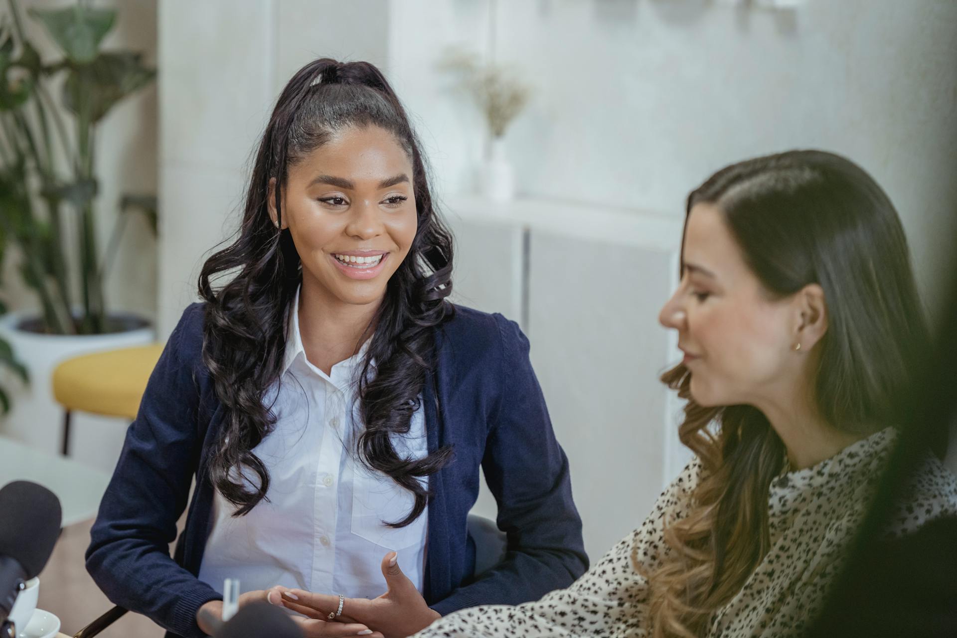 Two women speaking while being recorded on a microphone | Source: Pexels