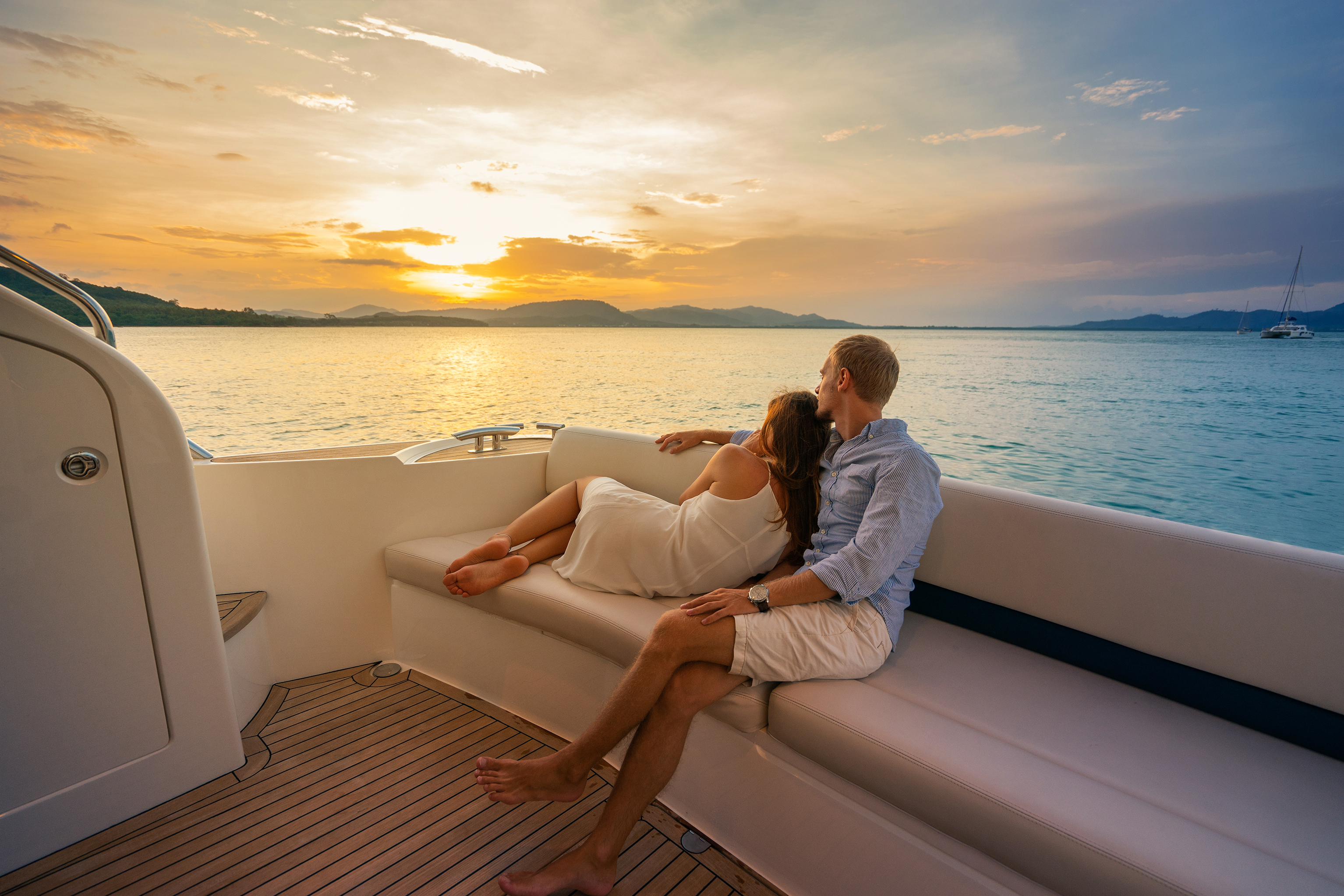 Romantic vacation . Beautiful couple looking in sunset from the yacht. | Source: Shutterstock