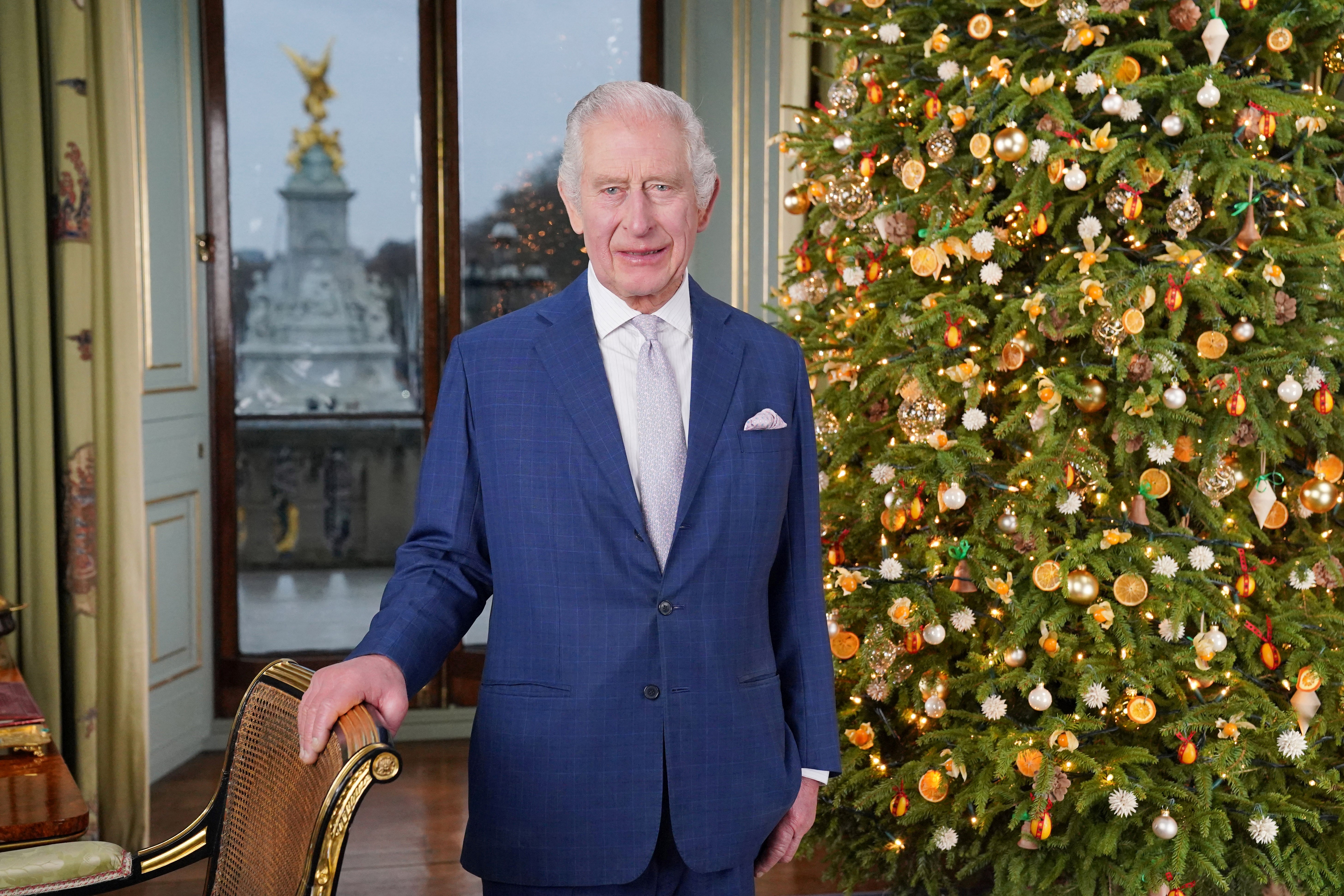 King Charles III poses during the recording of his Christmas message at Buckingham Palace, London, on December 7, 2023. | Source: Getty Images
