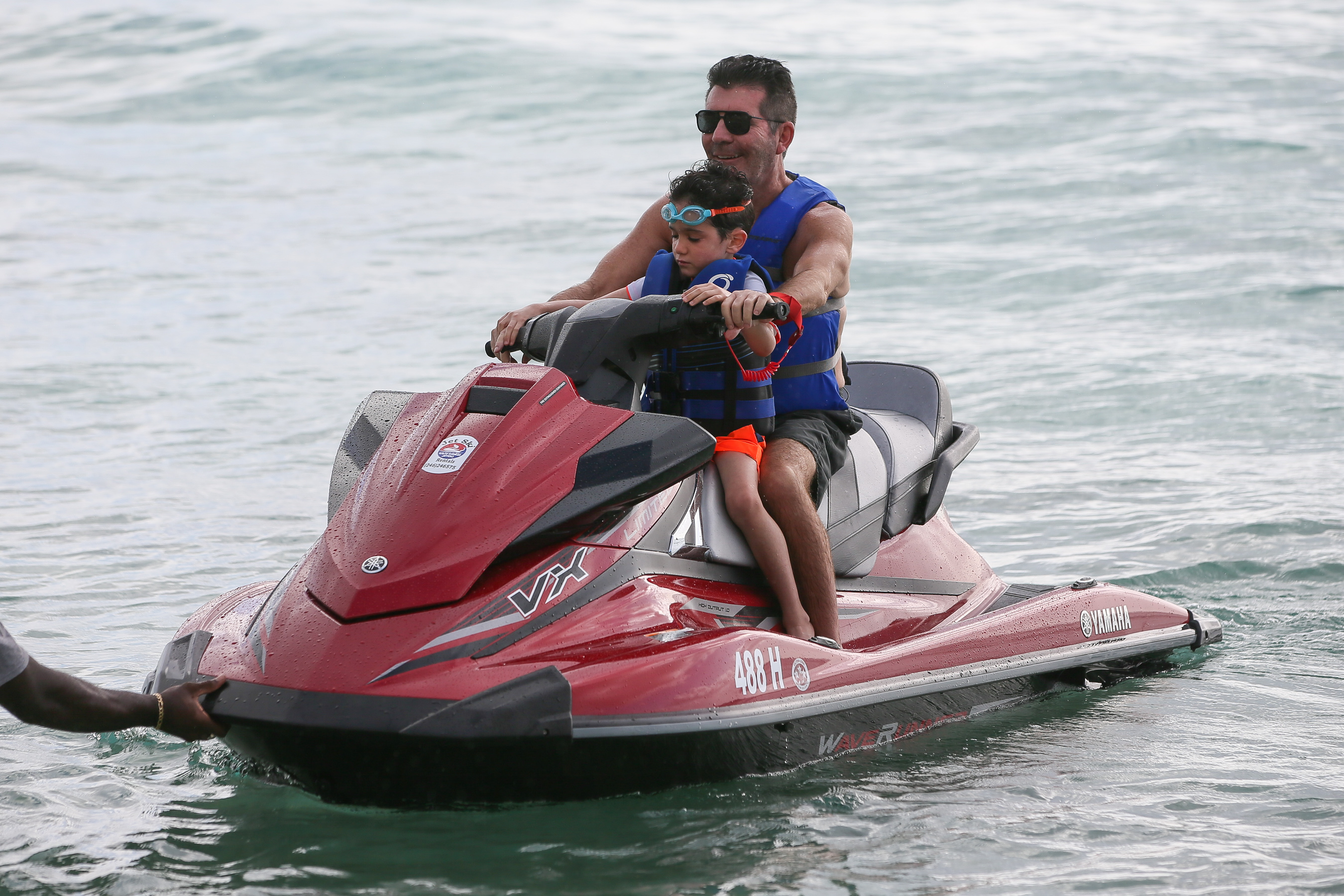 Simon Cowell seen jet skiing with his son Eric Cowell on December 18, 2019, in Bridgetown, Barbados | Source: Getty Images