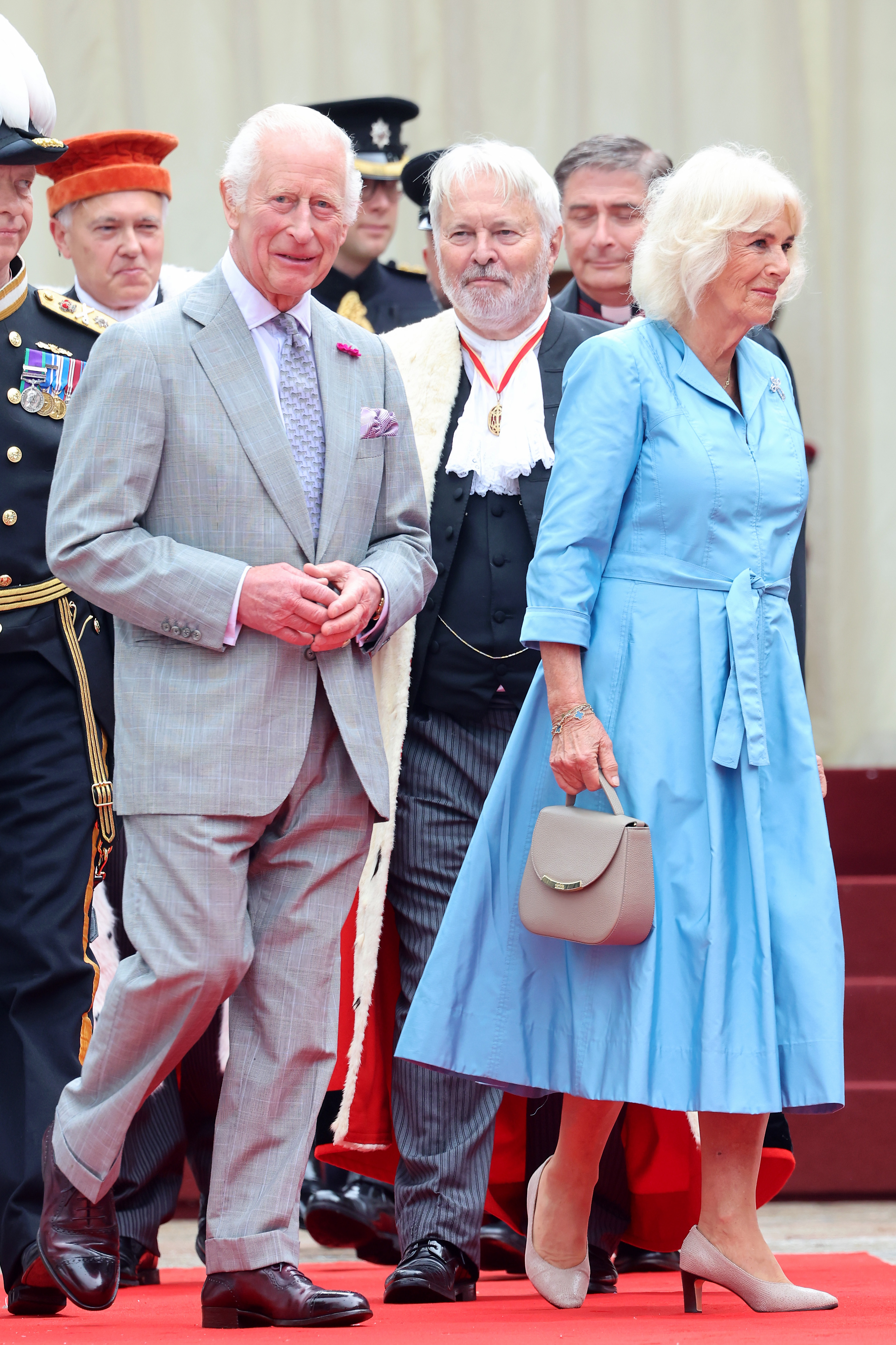 King Charles III and Queen Camilla walk to Royal Square for a Special Sitting of the States Assembly and Sitting of the Royal Court in St. Helier, Jersey on July 15, 2024. | Source: Getty Images