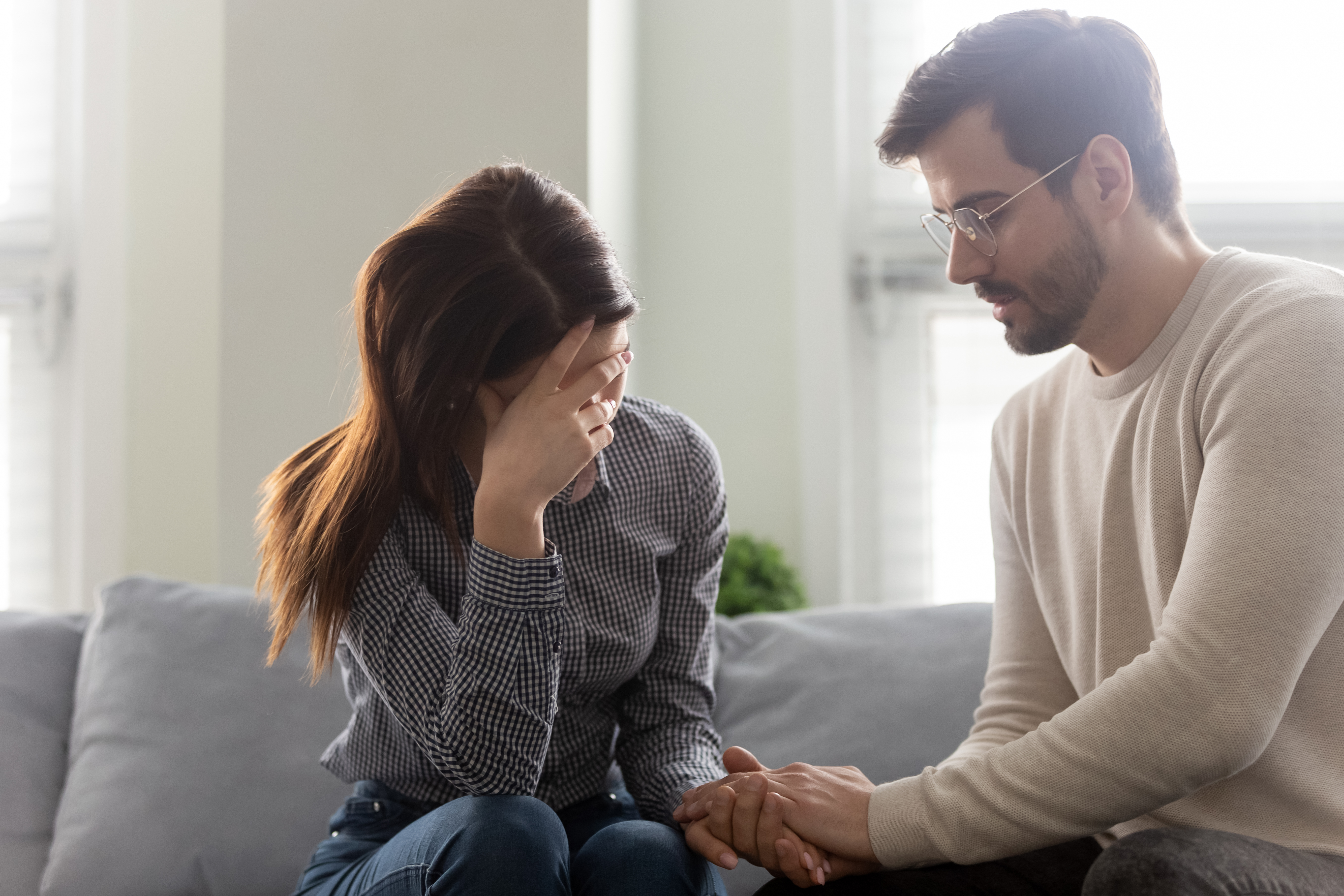 Husband comforting his depressed wife | Source: Shutterstock
