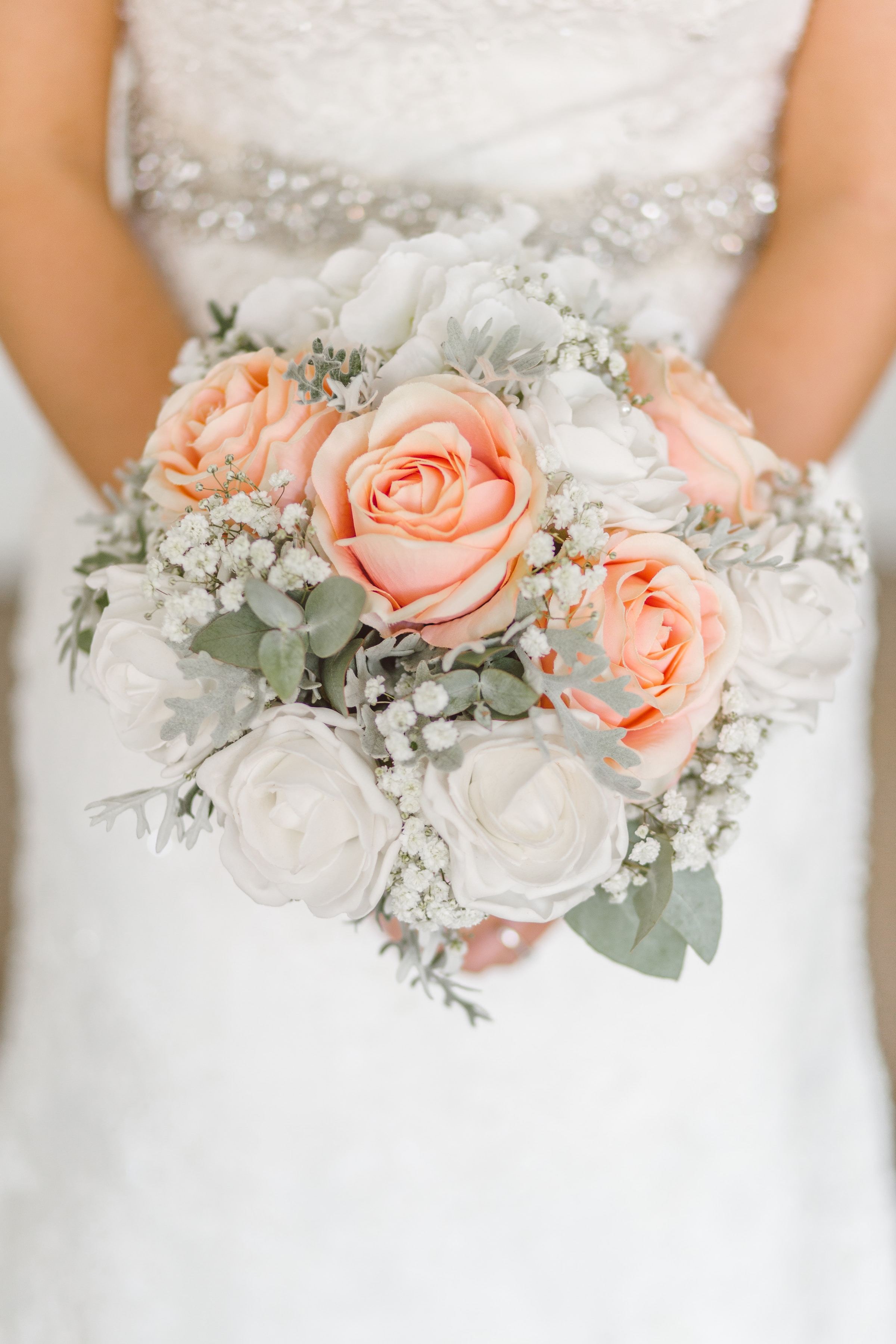 A bride in a white wedding gown holding flowers | Source: Unsplash